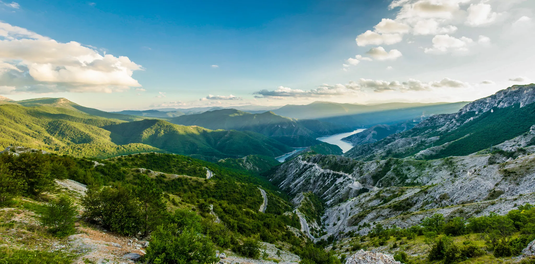 Photo showing: 500px provided description: Landscape over the Kozjak Lake nearby Skopje [#sky ,#landscape ,#mountains ,#water ,#nature ,#river ,#blue ,#sun ,#clouds ,#green ,#panorama ,#pano]