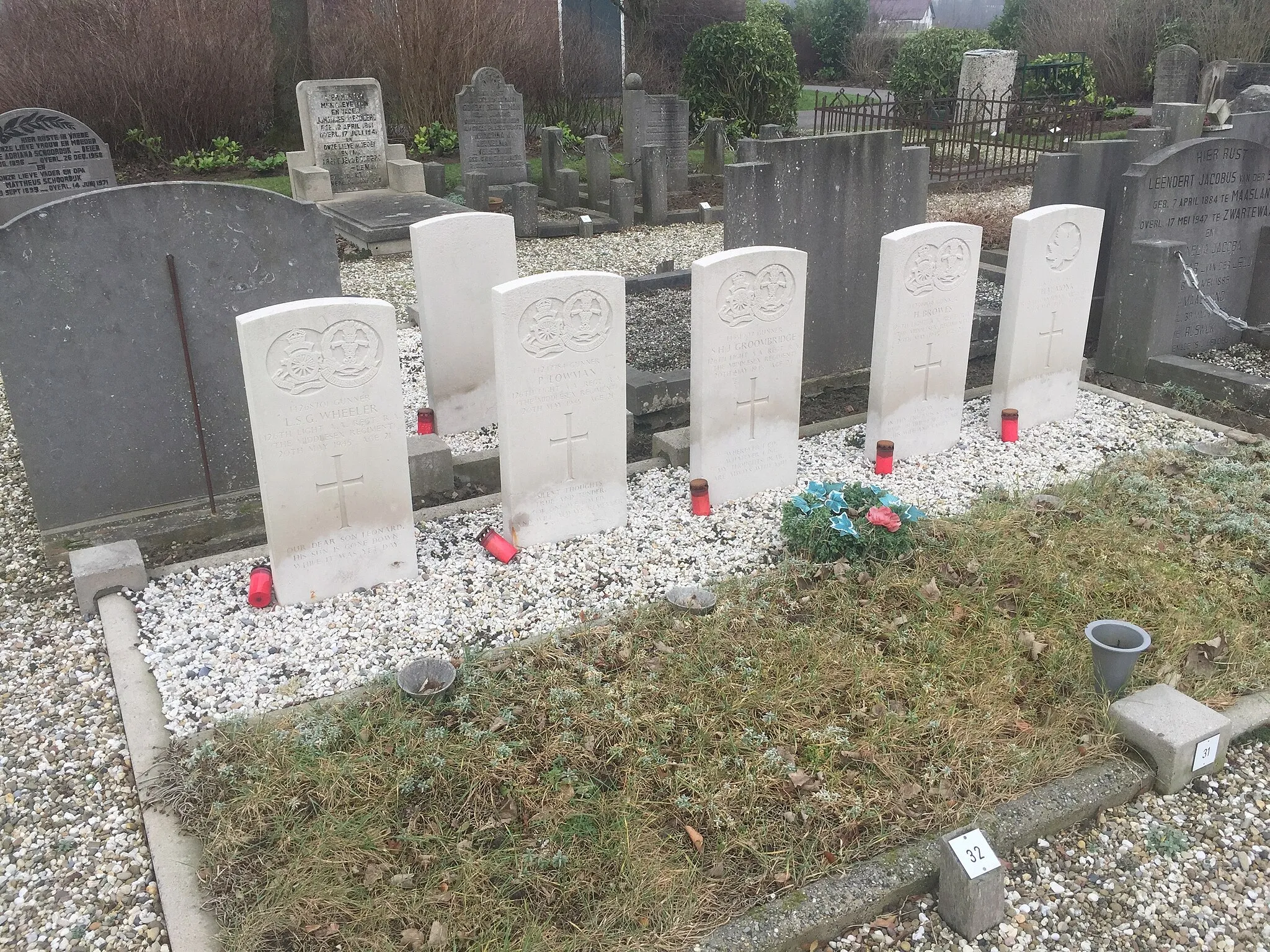 Photo showing: Commonwealth War Graves in the General Cemetery of Zwartewaal in the Netherlands. Farthest to the right is the grave of Lance Sergeant Henry Monk, Royal Canadian Artillery. The other four graves facing the camera are of members of 126 Light Anti-Aircraft Regiment (9th Battalion, Middlesex Regiment). All five soldiers died on 20 May 1945. Behind them is another Commonwealth War Grave, which is probably that of Flight Lieutenant Ivor Worthington-Wilmer, of 18 Squadron RAF, who died on 4 July 1940.