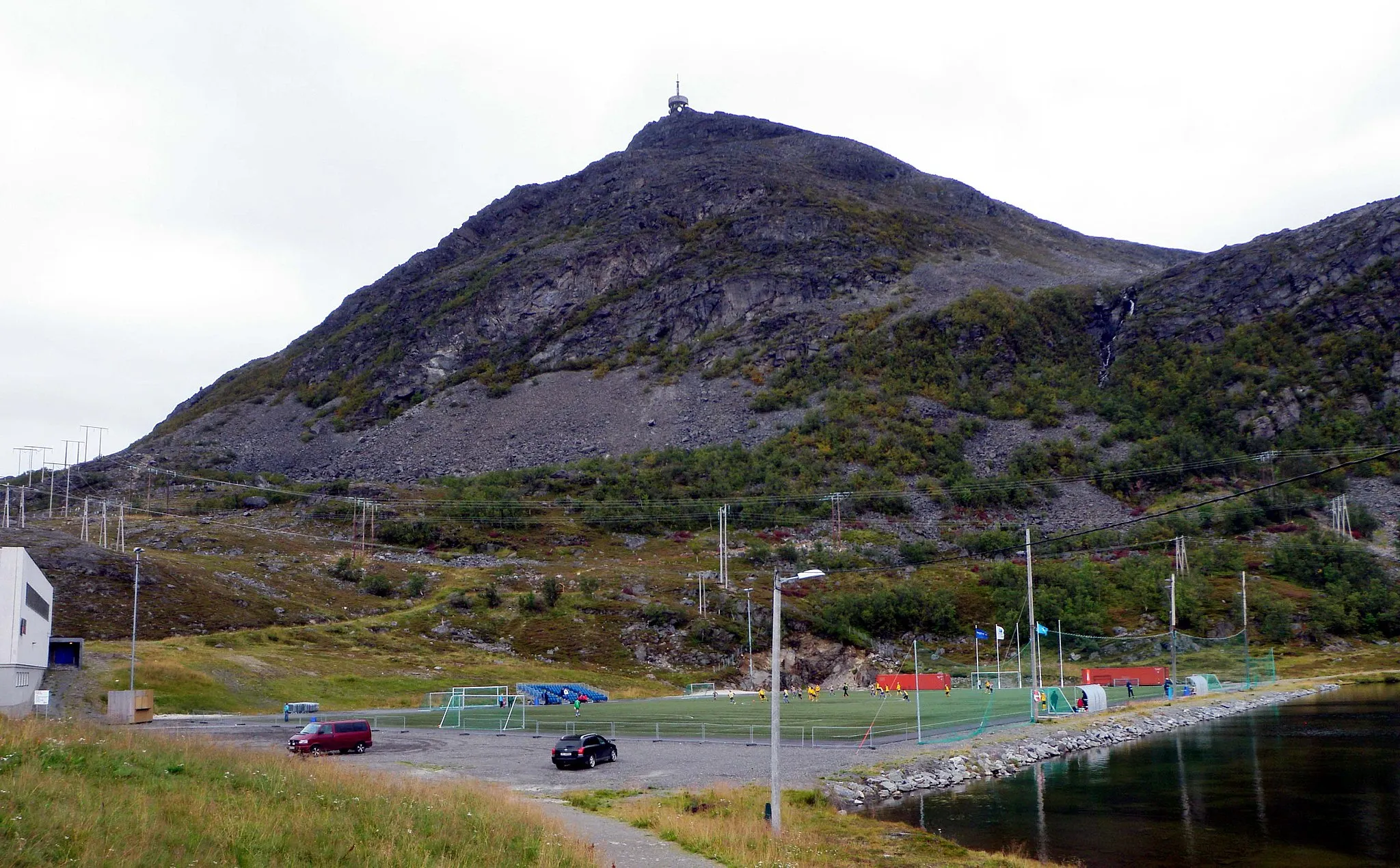 Photo showing: Breidablikk stadion, home venue of the football club Hammerfest FK, in Rypefjord in Hammerfest, Norway. The mountain Tyven in the background.