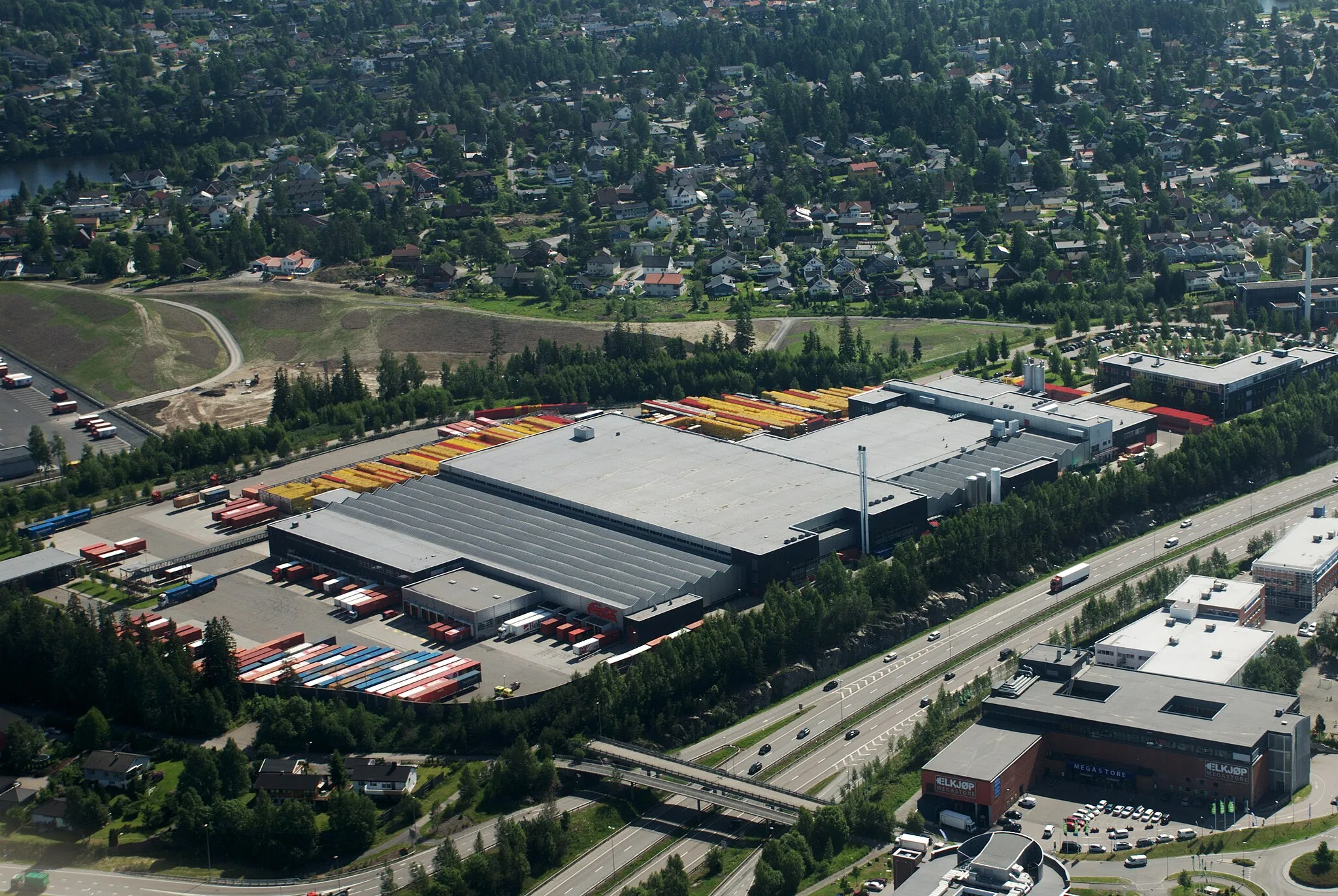 Photo showing: Coca-Cola Drikker på Robsrud i Lørenskog, rett over kommunegrensa til Oslo. Riksvei 159 midt i bildet, boligområde på Kjenn i bakgrunnen.