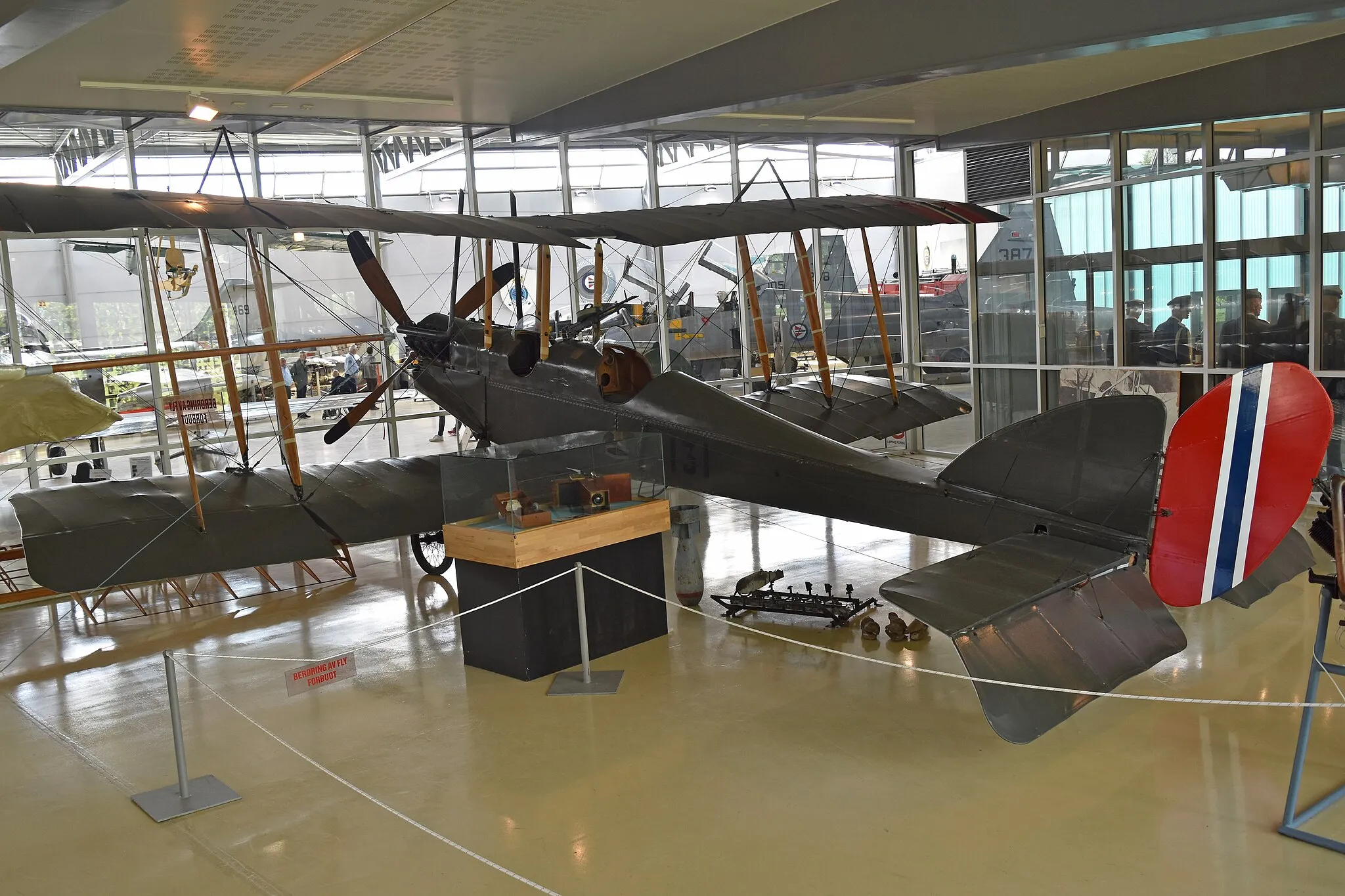 Photo showing: Built 1916 for the Royal Flying Corps as ‘A1380’.
Transferred to Norway in 1917 and numbered ‘59’ but placed in storage. Made airworthy in January 1919 and renumbered as ‘131’. It served until retired from service in November 1924.
Now on display in a controlled environment as part of the Flysamlingen Forsvarets Museer (Norwegian Armed Forces Aircraft Collection).
Oslo Gardermoen, Norway.
26th May 2019
The following information is from the museum website:-
“The Norwegian Armed Forces Air Collection B.E.2e, with British serial number A1380, was built off under contract by the company Wm. Denny & Bros. in Dumbarton in 1916. The plane arrived at Kjeller on September 5, 1917 and first reserved the Army's flying arm number 59, but was put into stock until further notice. When a new number sequence was awarded in September 1918, the aircraft was 131th.

The machine was tested on 22 January 1919 and delivered to the Sonfjellske flying department at Kjeller on 18 March of that year. No. 131 was scrapped on November 8, 1924 due to great wear and tear. The plane then had a total flying time of 110 hours and 59 minutes. In 1977 it was fully restored under the auspices of the Defence Museum”