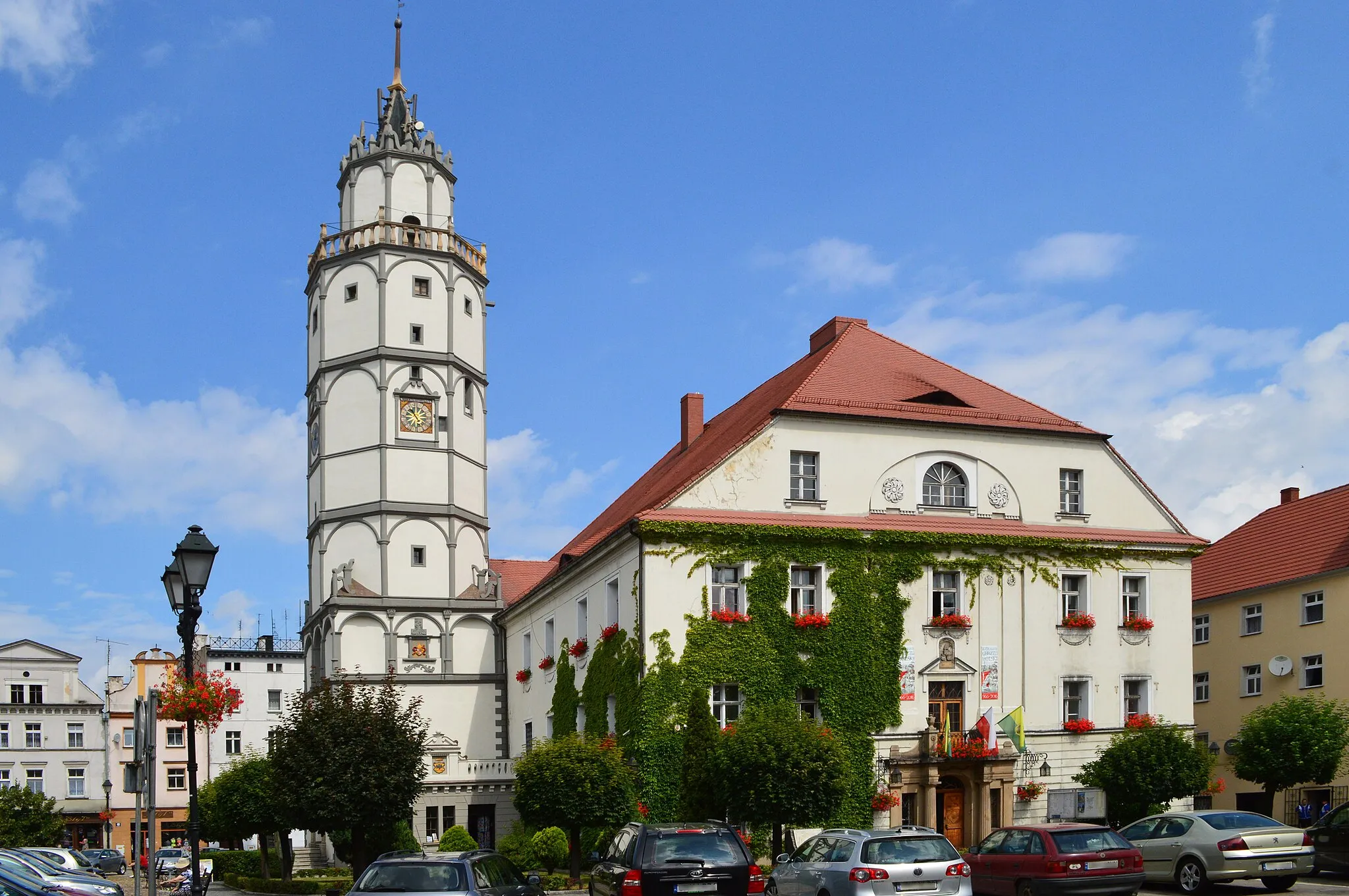 Photo showing: Paczków is a town in Nysa County, Opole Region, Poland. It is one of the few towns in Europe in which medieval fortifications have been almost completely preserved.  Located in the southeastern outskirts of the historical province of Lower Silesia, along the medieval road from Lesser Poland to Klodzko Valley and Prague, Paczków is called the "Polish Carcassonne", thanks to its well-preserved medieval fortifications.   However, while the famous French Carcassonne is a nineteenth century reconstruction, all historic buildings of Paczków are authentic.  The old town and its medieval fortifications are listed as one of Poland's official national Historic Monuments (Pomnik historii), which listing is maintained by the National Heritage Board of Poland.
Paczków (the name comes from the old Slavic first name Pakoslaw) was officially founded on March 8, 1254, when the Bishop of Wrocław, Tomasz I gave permission for the location of a new town. It was placed near the ancient village of Paczków, and henceforth, the name of the village was changed to Old Paczków. Paczków quickly grew, becoming not only a market town, but also a stronghold, guarding the southwestern borders of the mighty ecclesiastical Duchy of Nysa. It was granted the so-called Flemish rights, based on the Magdeburg rights.
In the late Middle Ages and subsequent periods, Paczków shared the stormy fate of other towns of Silesia, with frequent disasters, such as hunger (1325), floods (1333, 1501, 1539, 1560, 1598, 1602), fires (1565, 1634), as well as epidemics - Black Death (1349), and cholera (1603–1607, 1633). Paczków also suffered during the Hussite Wars, when it was captured by the Hussites on March 17, 1428. The period of religious wars did not end until the late fifteenth century, and only then did Paczków begin to flourish again. With the financial support of the bishops of Nysa, new fortifications were constructed, with a defensive and towers. 
In 1526 Paczków, together with the whole of Silesia, passed to the Austrian Habsburg dynasty (see also Silesian Piasts). During the Thirty Years' War warring armies destroyed Paczków and adjacent areas. In 1742, after the Silesian Wars, Paczków was annexed by the Kingdom of Prussia (see also Austrian Silesia), and it subsequently became part of the German Empire. Following the Potsdam Agreement, the town was placed under Polish administration, and its German population was largely replaced with Poles, most of whom came from ‘Western Ukraine’ (see: Kresy), from the areas of Lviv, Ternopil, and Volhynia.

Besides its fortifications, Paczków is famous for renaissance, baroque, and neoclassic tenement houses, which surround the town square and the town hall. The oldest of these buildings dates back to around 1500, with the most visible being the so-called "House of the Executioner". Another interesting monument of the "Polish Carcassonne" is the Church of John the Evangelist, which is considered to be one of the most impressive fortified churches in Poland.  Its construction began in 1350, and lasted for 30 years. The unique ‘Gothic’ church, which is made of stone and bricks displays a renaissance attic, and its mighty structure has been incorporated into the town's fortifications.  The church stands out because of its immense size, and inside there are sculptures attributed to Wit Stwosz. Next to the complex there is the so-called Tatar well. According to a legend, a Tatar warrior (see Mongol invasion of Poland) was thrown into the well, after he had captured the daughter of a wealthy inhabitant of Paczków. The Scotch Mist Gallery contains many photographs of historic buildings, monuments and memorials of Poland.