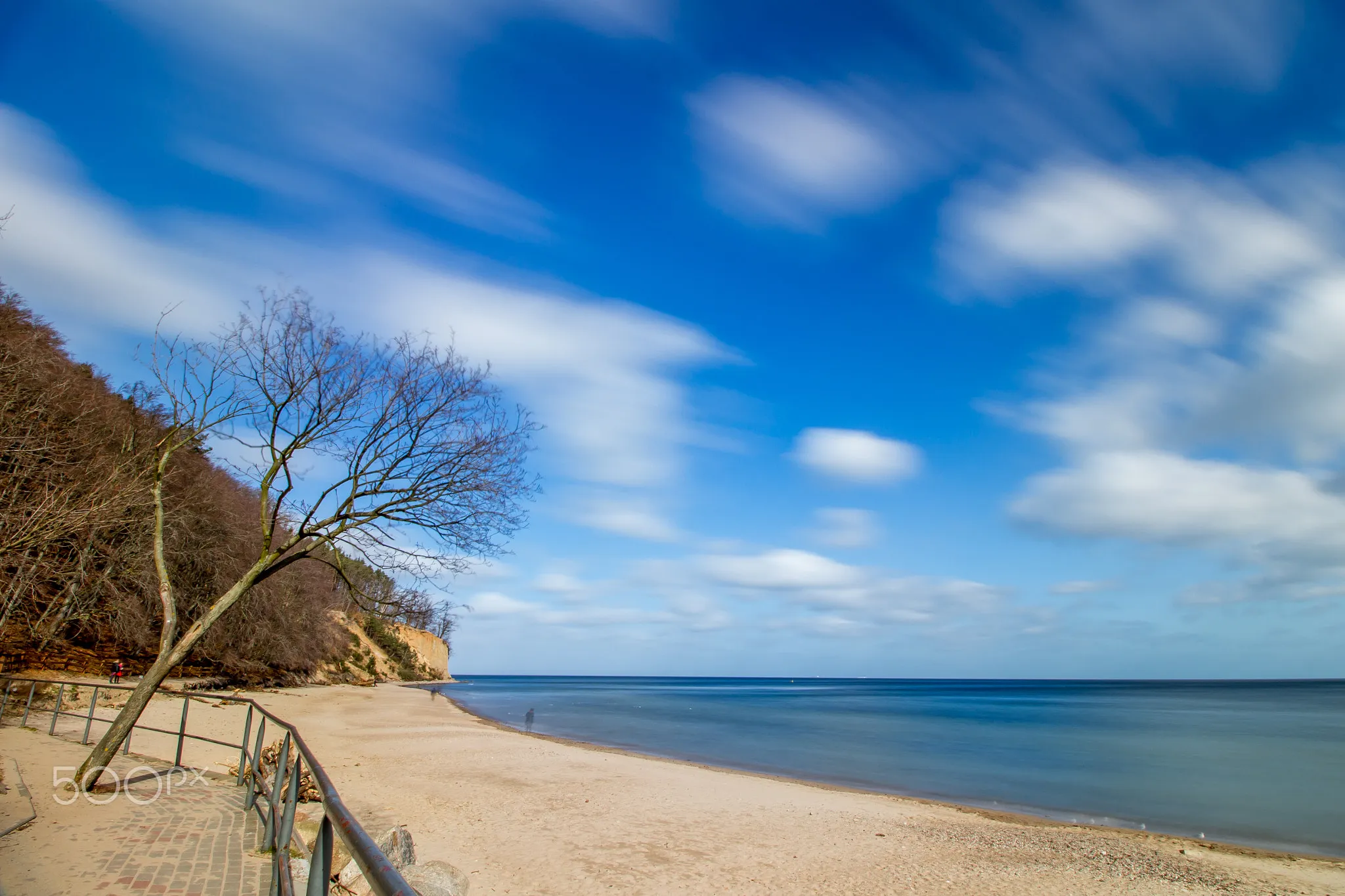 Photo showing: 500px provided description: 18 [#trees ,#sky ,#sea ,#water ,#beach ,#blue ,#sun ,#light ,#clouds ,#tree ,#sand]