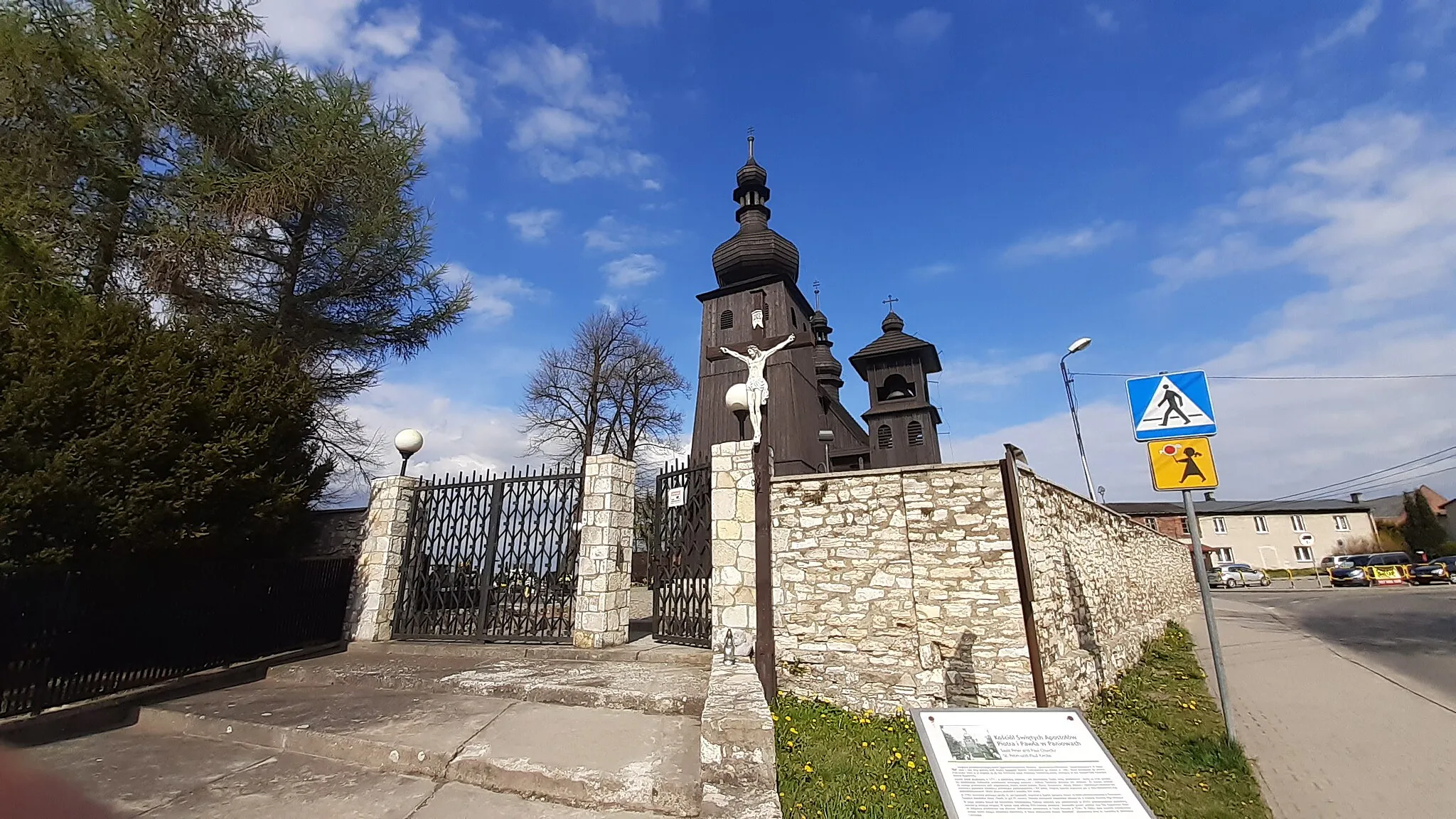 Photo showing: Kościół Świętych Apostołów Piotra i Pawła w Mikołowie-Paniowach, widok zza bramy, z widoczną tablicą inforamcyjną