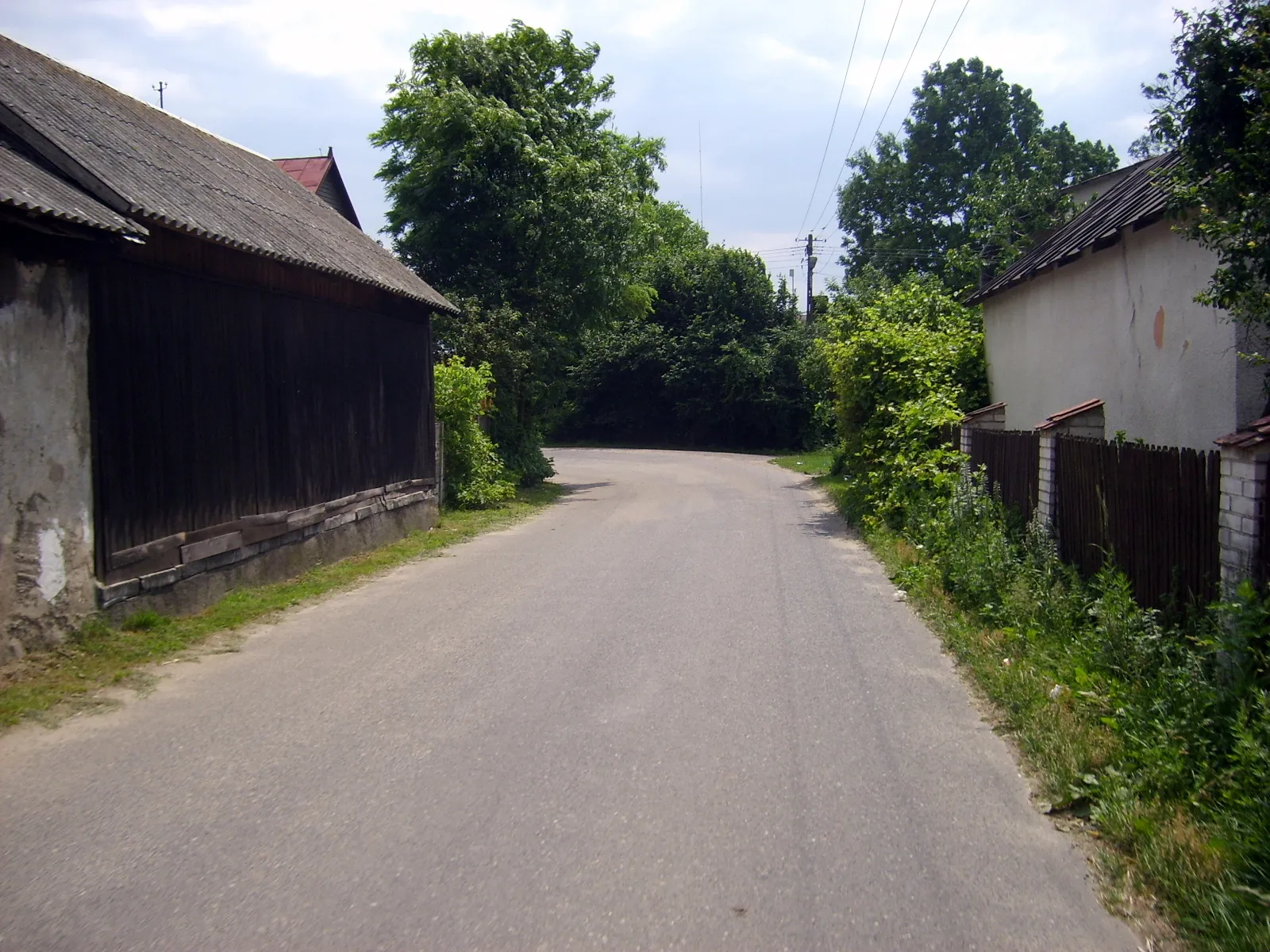 Photo showing: Kamienica-Kozaki (północna część wsi Kamienica). Droga ze Strzembowa w pobliżu kościoła. 2007 r.