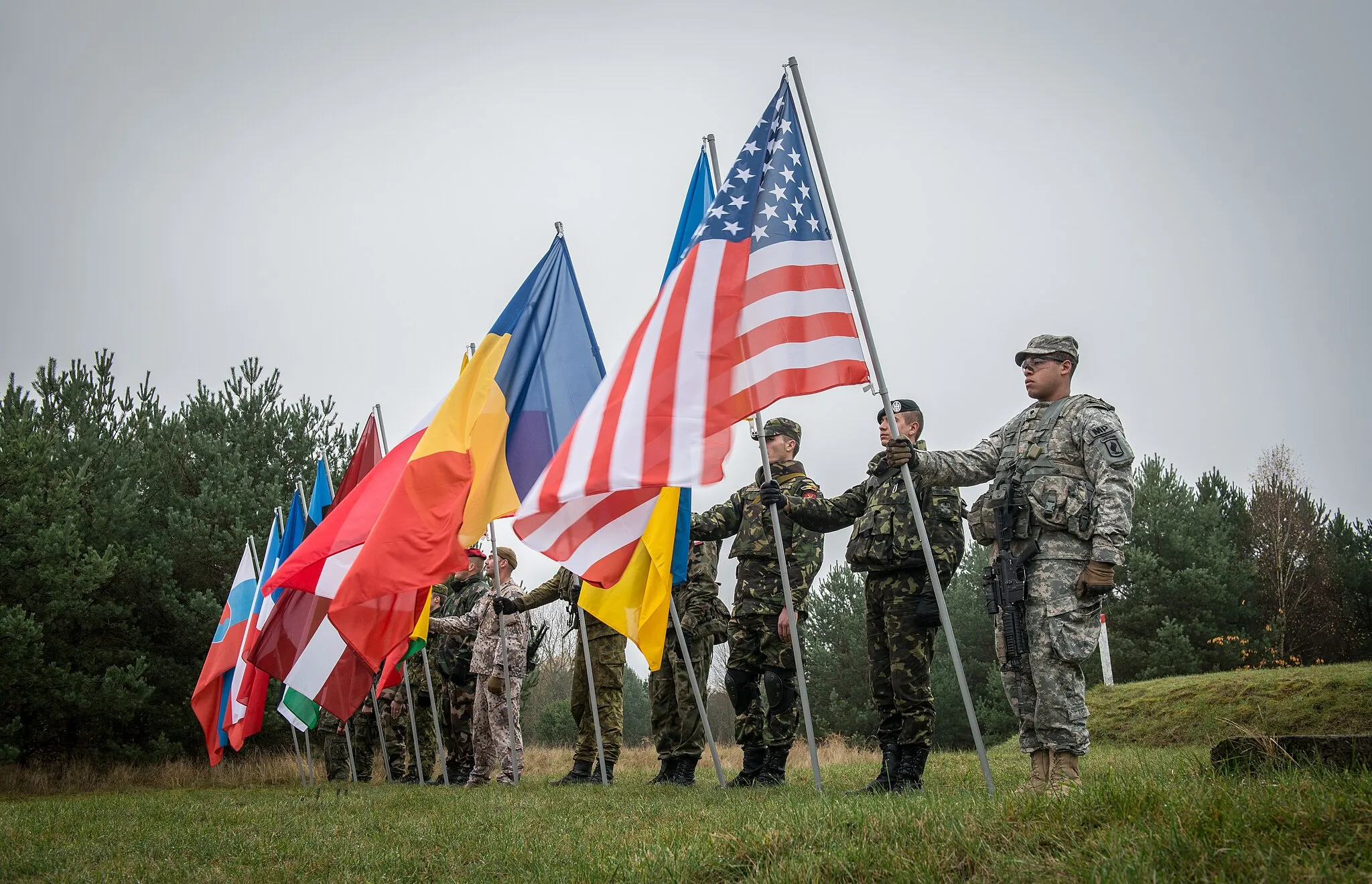 Photo showing: The Opening Ceremony for Ex STEADFAST JAZZ took place on the Drawsko Pomorskie Training Area, Poland, on Nov. 3, 2013.
Exercise Steadfast Jazz 2013 is taking place from 1-9 November in a number of Alliance nations including the Baltic States and Poland.  The purpose of the exercise is to train and test the NATO Response Force, a highly ready and technologically advanced multinational force made up of land, air, maritime and special forces components that the Alliance can deploy quickly wherever needed.  The Steadfast series of exercises are part of NATO’s efforts to maintain connected and interoperable forces at a high-level of readiness.

(NATO photo/SSgt Ian Houlding GBR Army)