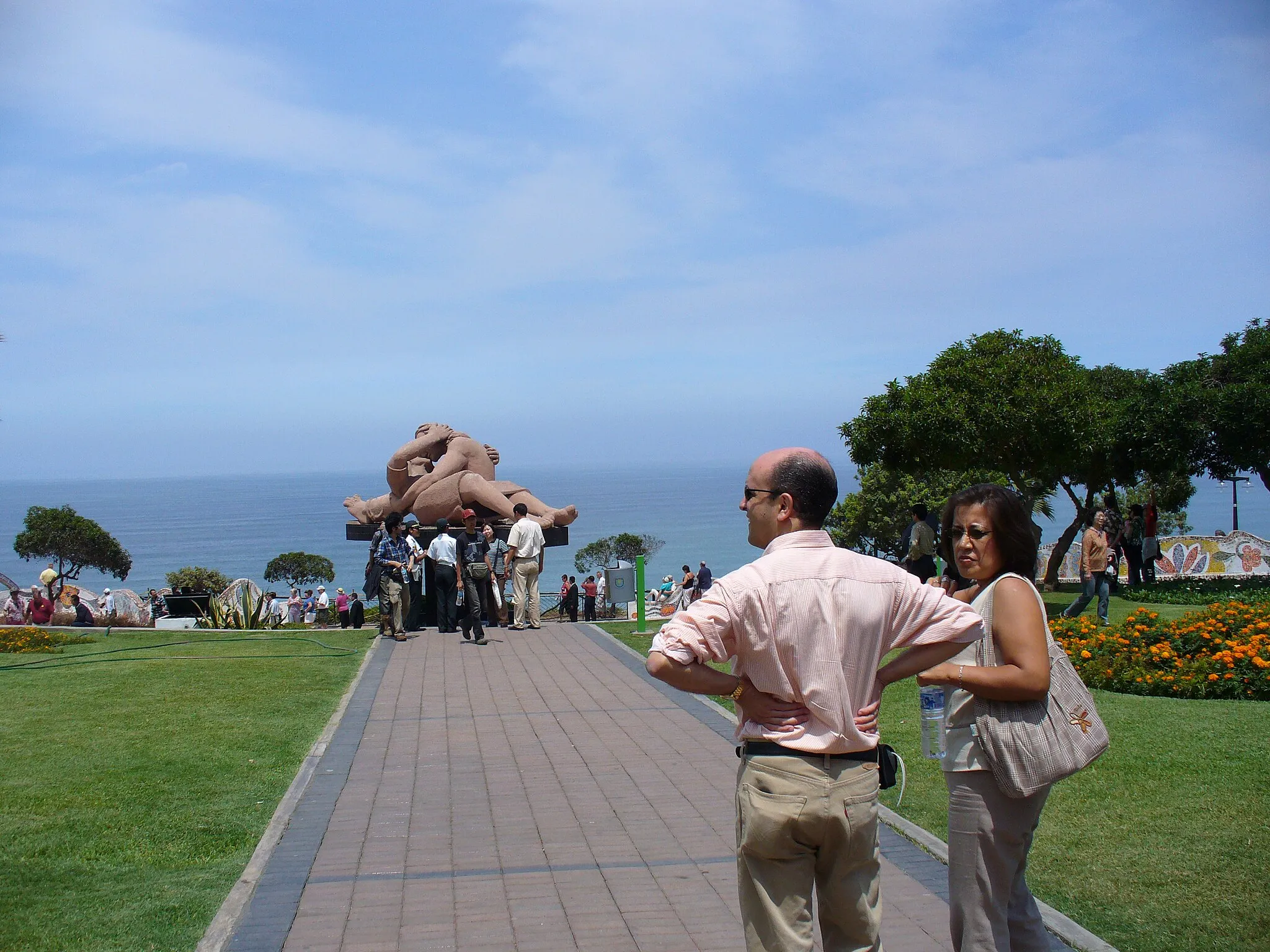 Photo showing: Tourists enjoying Love Park in Lima, Peru, with the statue el beso by Victor Delfín in the background