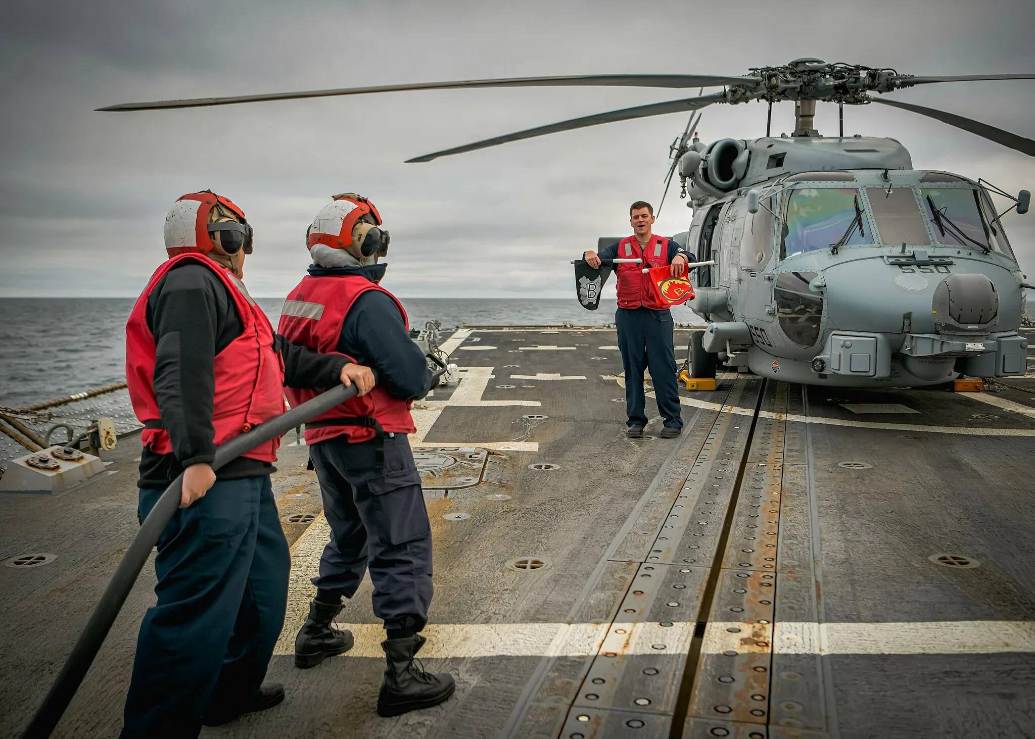 Photo showing: Machinery Repairman 1st Class Patrisha Castro (left)  and Damage Control 3rd Class Amber Blanks participate in a crash and salvage drill on The Arleigh Burke-class guided-missile destroyer USS Oscar Austin (DDG 79) during exercise Formidable Shield 2023 while operating in the North Atlantic Ocean, May 12, 2023. Formidable Shield is a biennial integrated air and missile defense (IAMD) exercise involving a series of live-fire events against subsonic, supersonic, and ballistic targets, incorporating multiple Allied ships, aircraft, and ground forces working across battlespaces to deliver effects. (U.S. Air Force photo by Senior Airman Jan K. Valle)
