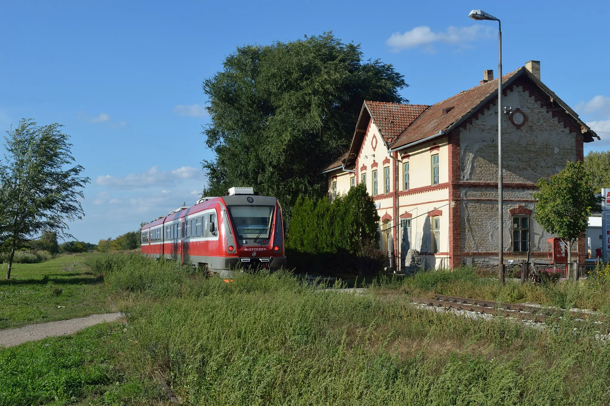 Photo showing: Balkans Rail Trip, Autumn 2013 - Day Two
Kanjiža sees two trains per day and marks the end of what was once a through line from Horgoš to Senta. Seen on 24 September 2013, 711.017 forms train 7487,    16:21 Kanjiža to Subotica.

These new 2-car DMUs built by Metrovagonmas in Russia as type RA2 are is in fact the first new passenger rolling stock for Serbia since the break up of the former Jugolslavia. Altogether 25 sets have been ordered and will be distributed to several depots around the network. These will eventually replace much of the older stock that has been in ownership since new or bought in second hand.