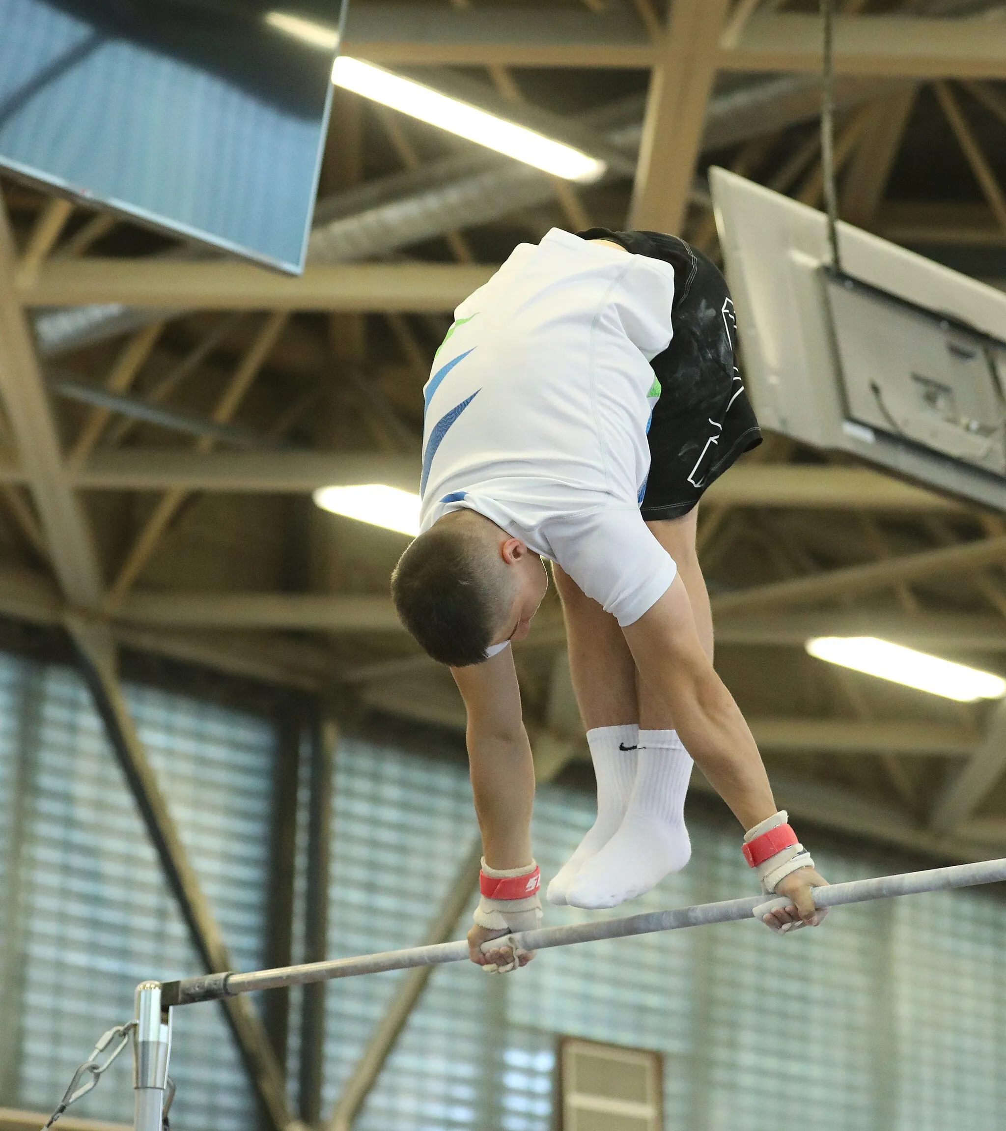 Photo showing: Horizontal bar exercise during the training at the 7th International Junior Budapest Cup on 24 June 2022. Depicted: Anže Hribar.