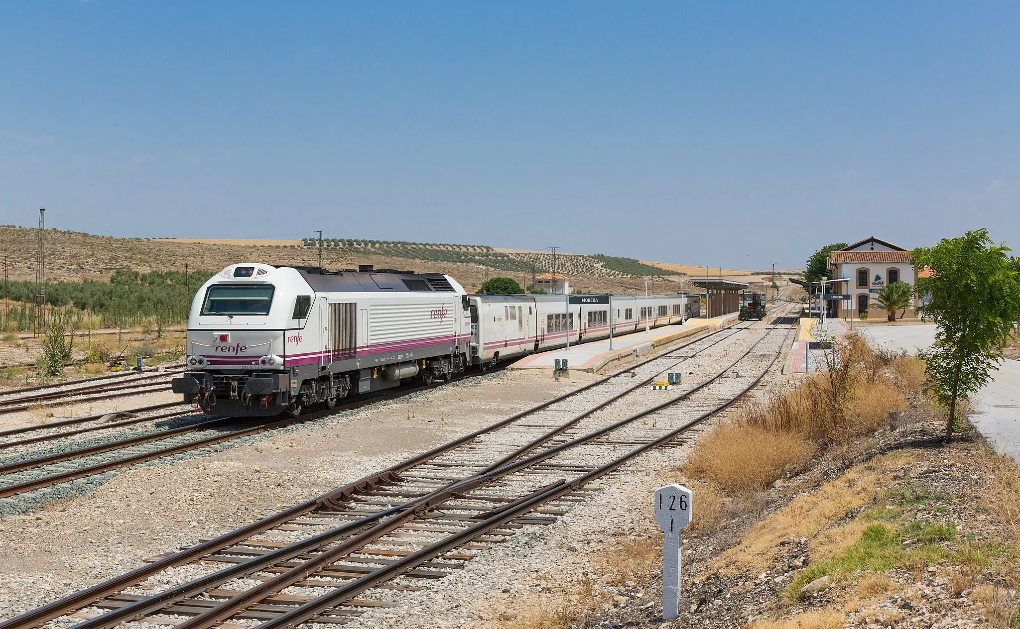 Photo showing: RENFE 334 011 with a Talgo set is leaving the station of Moreda, Spain.