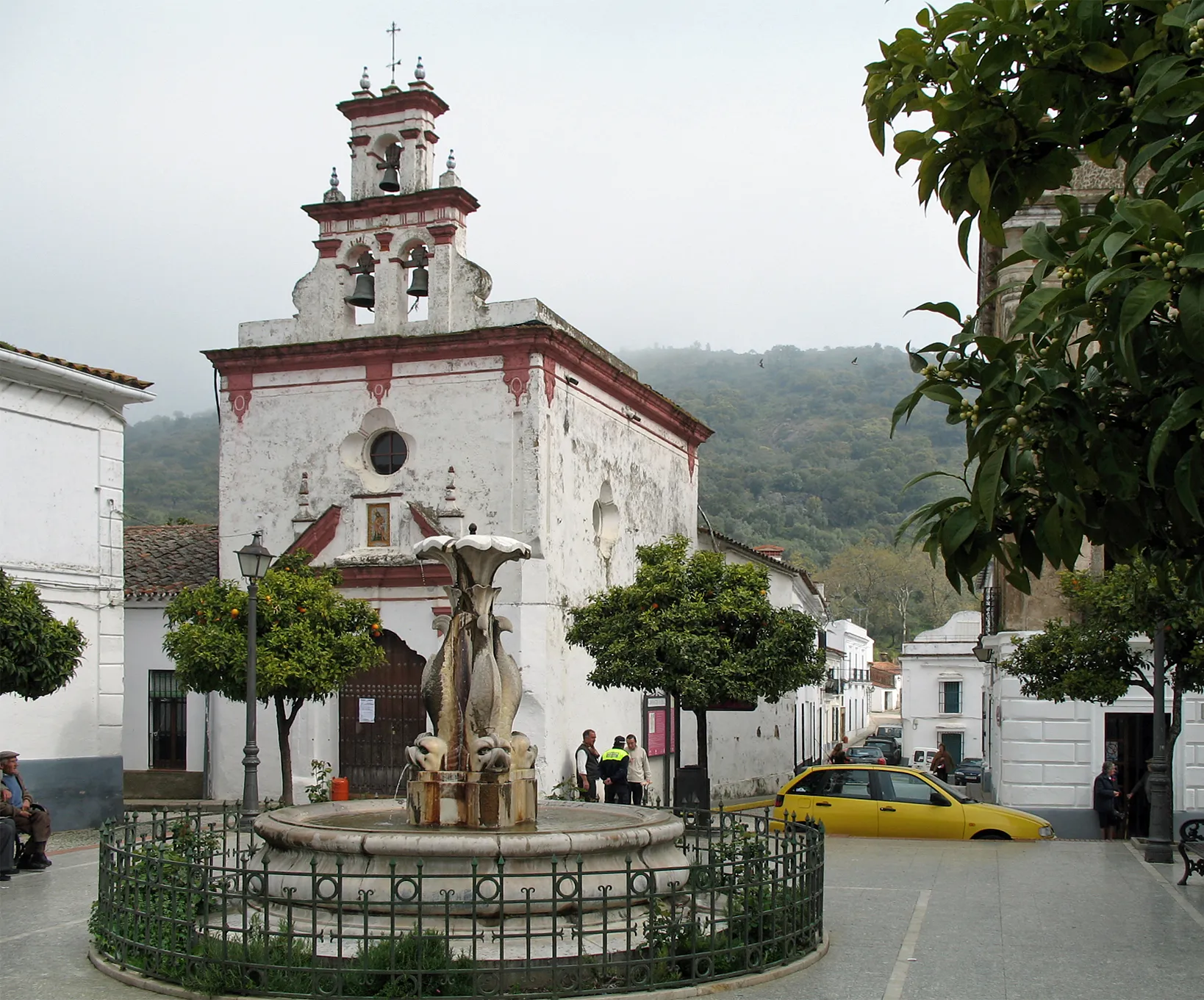 Photo showing: Almonaster la Real (province of Huelva, Andalusia, Spain): fountain on the main square and Ermita de la Trinidad