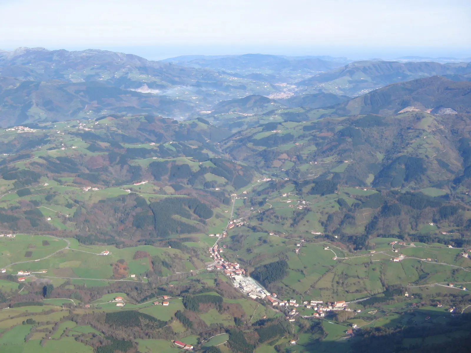 Photo showing: A view of Amezketa, the Oria valley, Hernio top left and a glimpse of San Sebastián and the Bay of Biscay in the far background, in Gipuzkoa, Basque Country of Spain