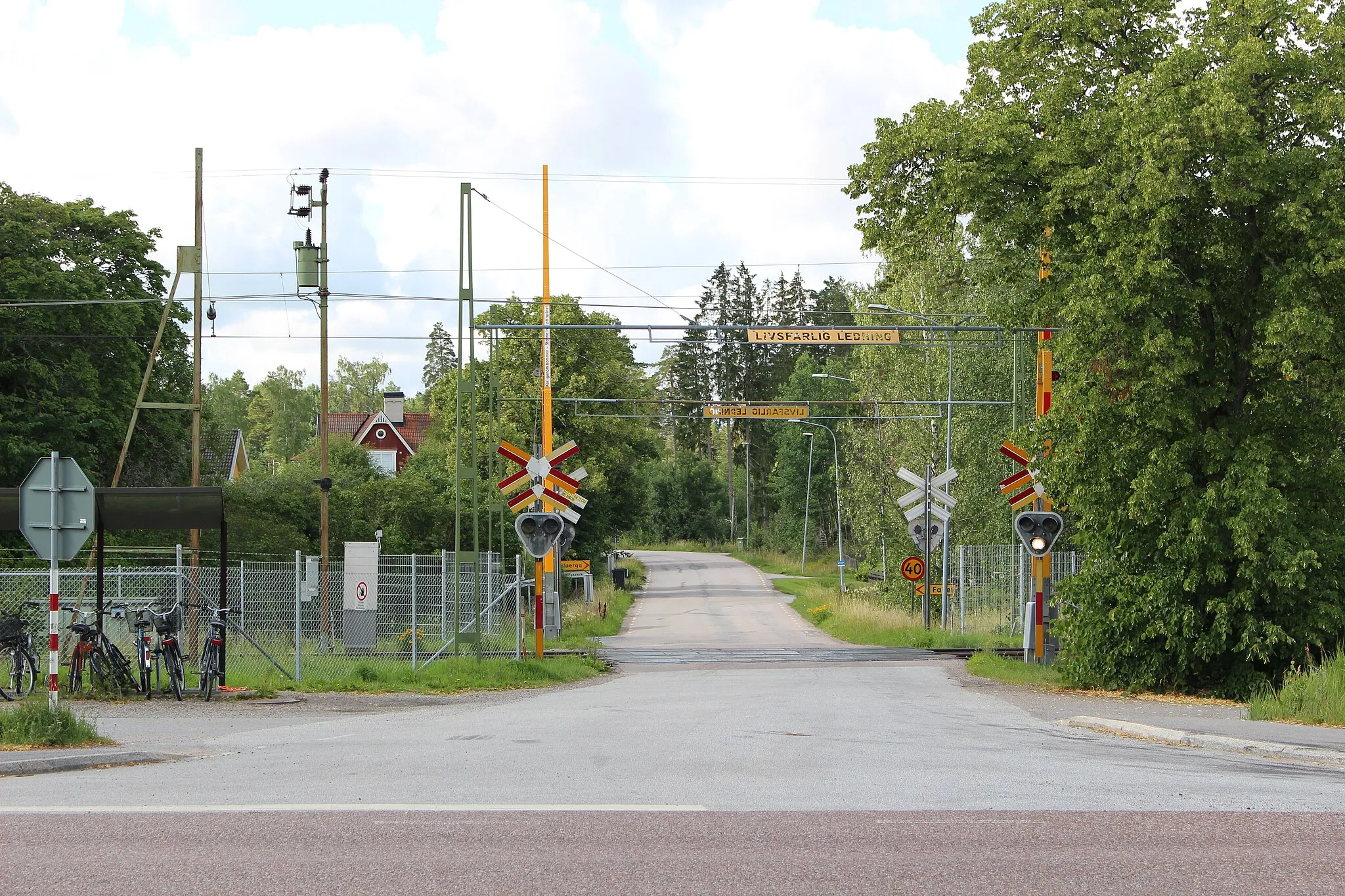 Photo showing: Järlåsa vid Riksväg 72. Vy mot söder. Ribbingebäcksvägen korsar Dalabanan via en järnvägsövergång.