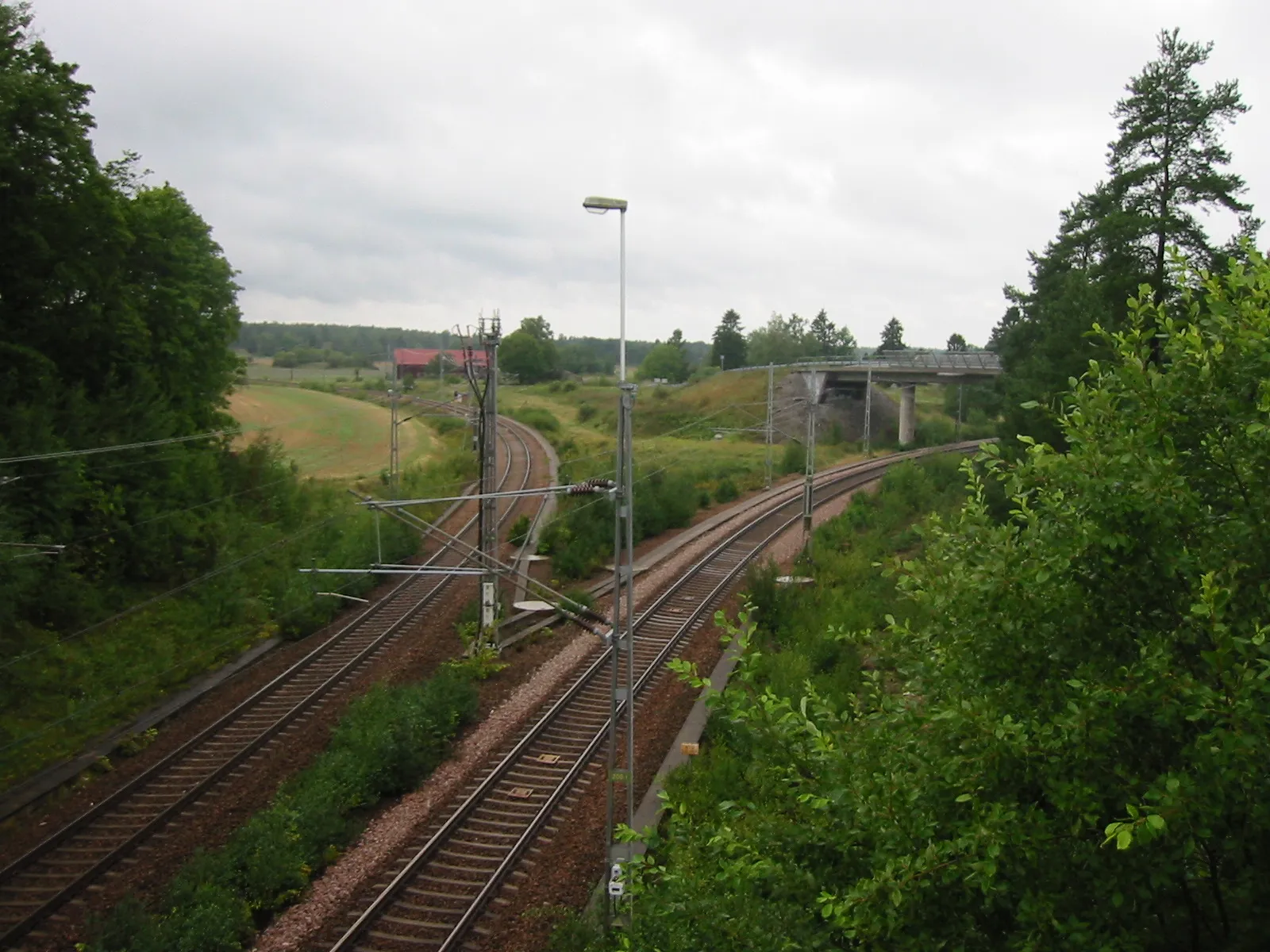 Photo showing: Tumbo, view west from road bridge. The track turning left is Svealandsbanan towards Kungsör and Arboga. The track turnning right is the track to Kvicksund and Kolbäck.