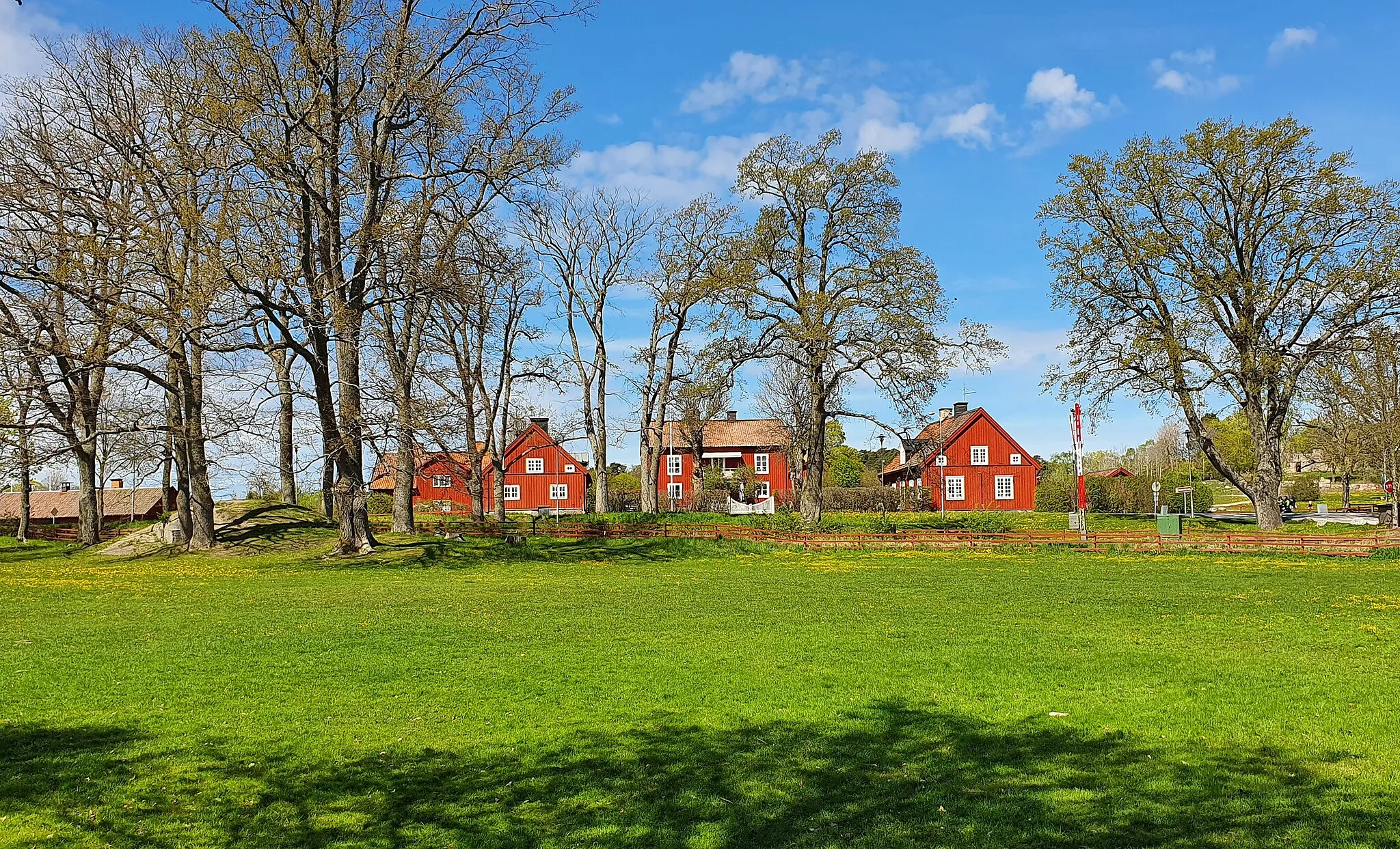 Photo showing: Gårdsbebyggelsen vid Gripsholms kungsladugård. Vy mot norr. Hitom gården går landsvägen och järnvägen.