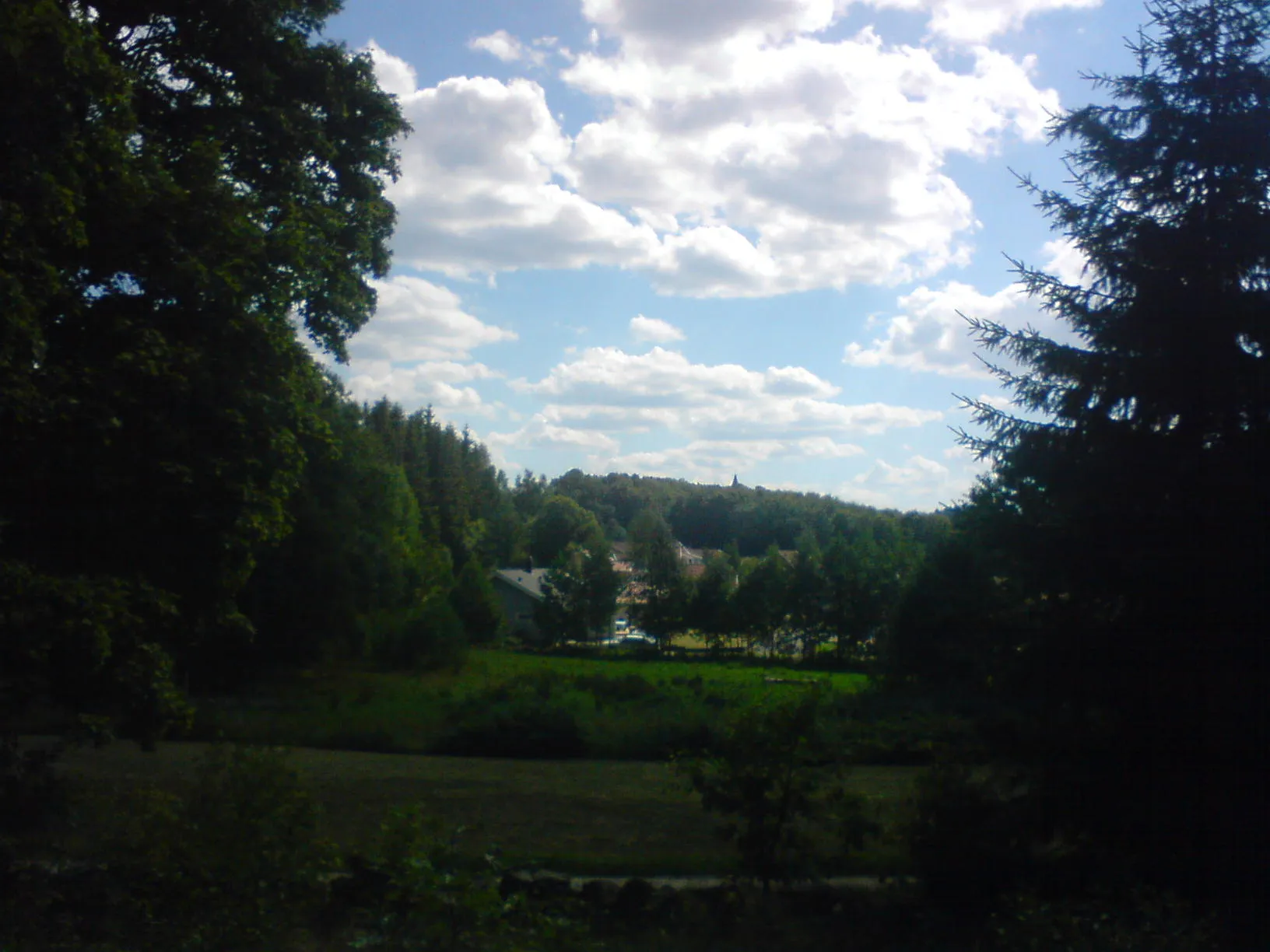 Photo showing: In this image the church spire of the parish church of sv:Ucklum, Sweden can be seen over the woods in the mittle of the picture. This image is from the north east.