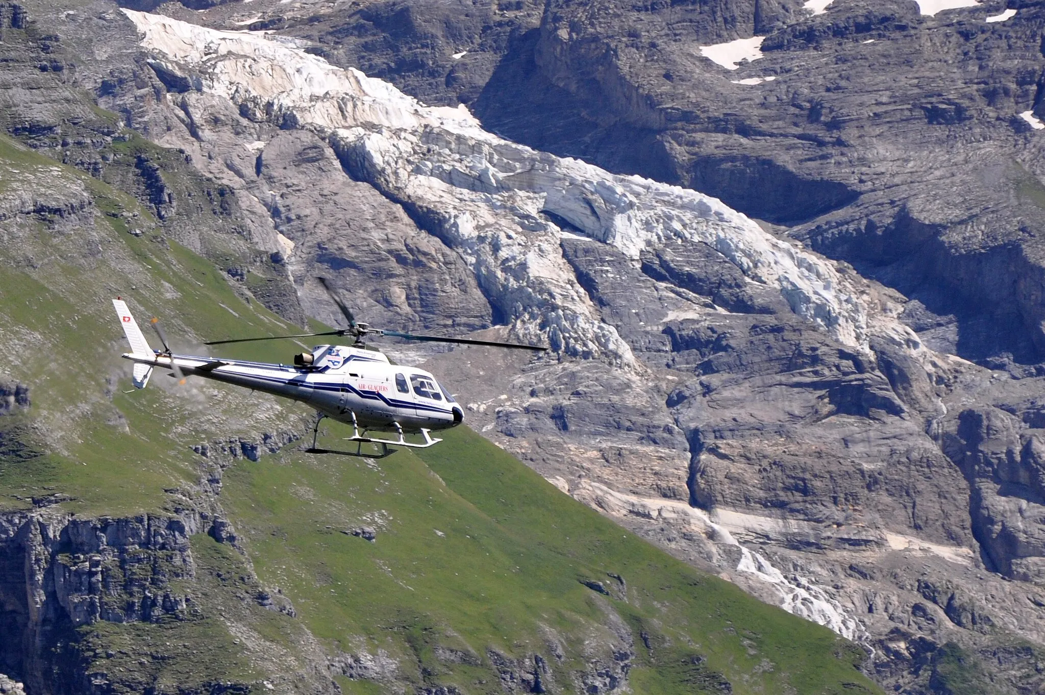 Photo showing: Switzerland, Canton of Bern,

Air Glacier Eurocopter HB-ZHO passing Mürren