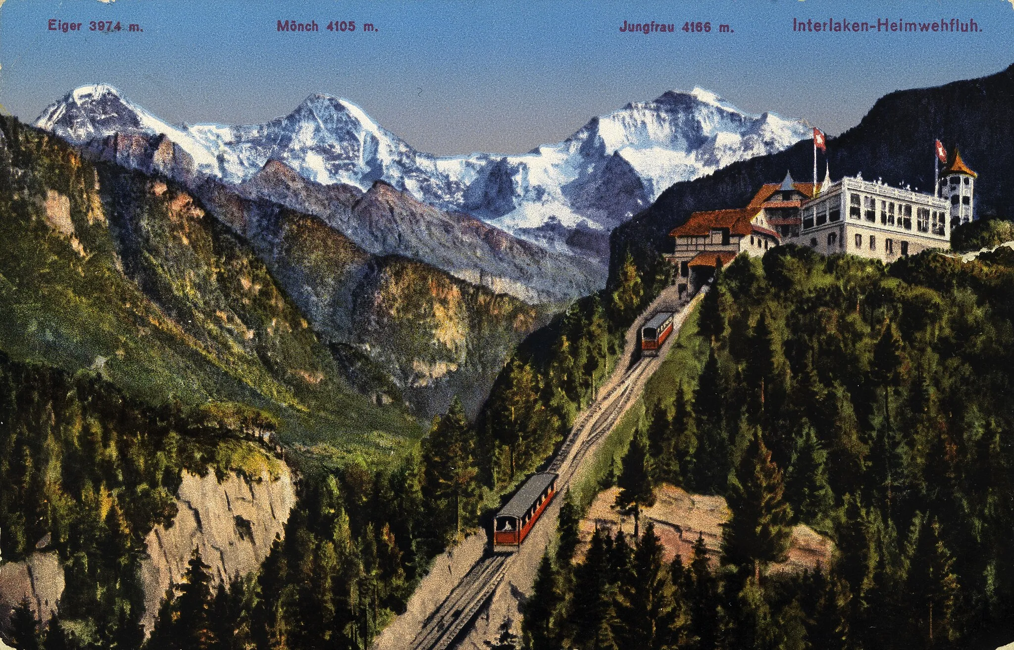 Photo showing: Hand-coloured postcard depicting the Funicular Interlaken–Heimwehfluh, with Eiger, Mönch and Jungfrau in the background. Stamped on September 1st 1918.