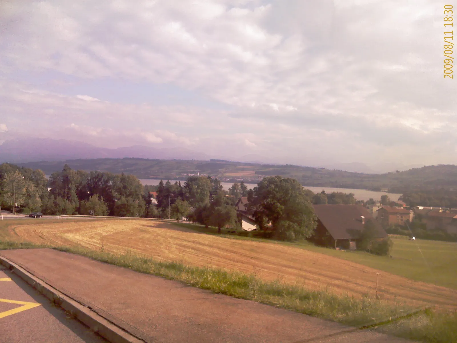 Photo showing: Panoramic view from bus stop Schenkon to the Lake Sempach, district Sursee, canton of Luzern, Switzerland. On the other side of Nottwil is visible.