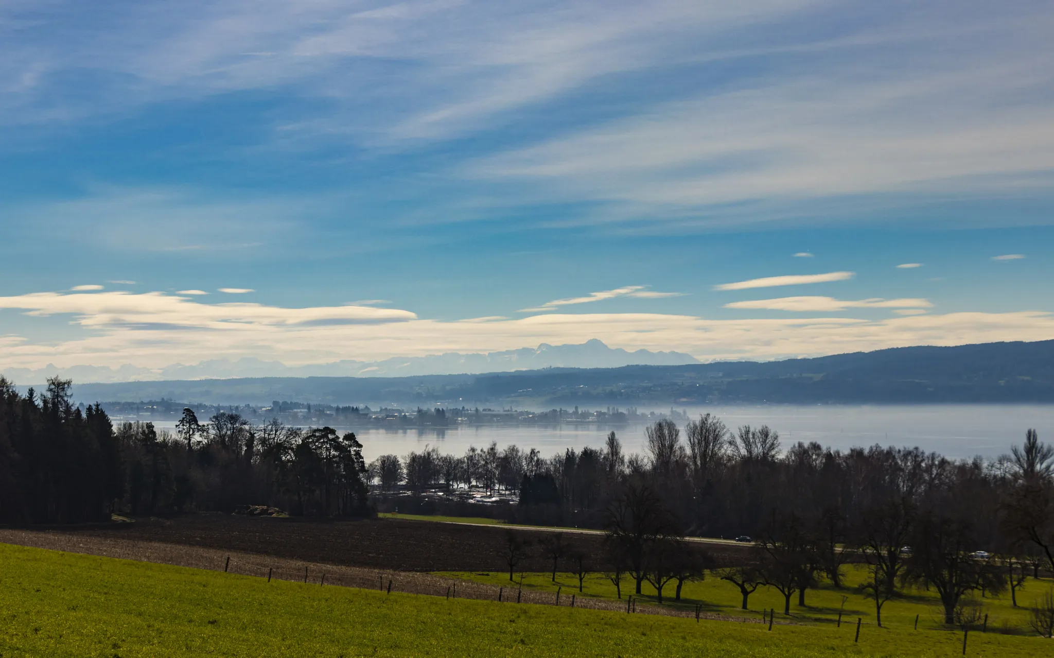 Photo showing: 500px provided description: M?rz 2018 Markelfingen

Sonnenaufgang / Sunrise [#field ,#landscape ,#lake ,#nature ,#river ,#clouds ,#grass ,#green ,#countryside ,#pasture ,#see ,#alps ,#bodensee ,#gr?n ,#natur ,#alpen ,#country road ,#wolken ,#insel ,#reichenau ,#horizon over land ,#fluss ,#lakeconstance]