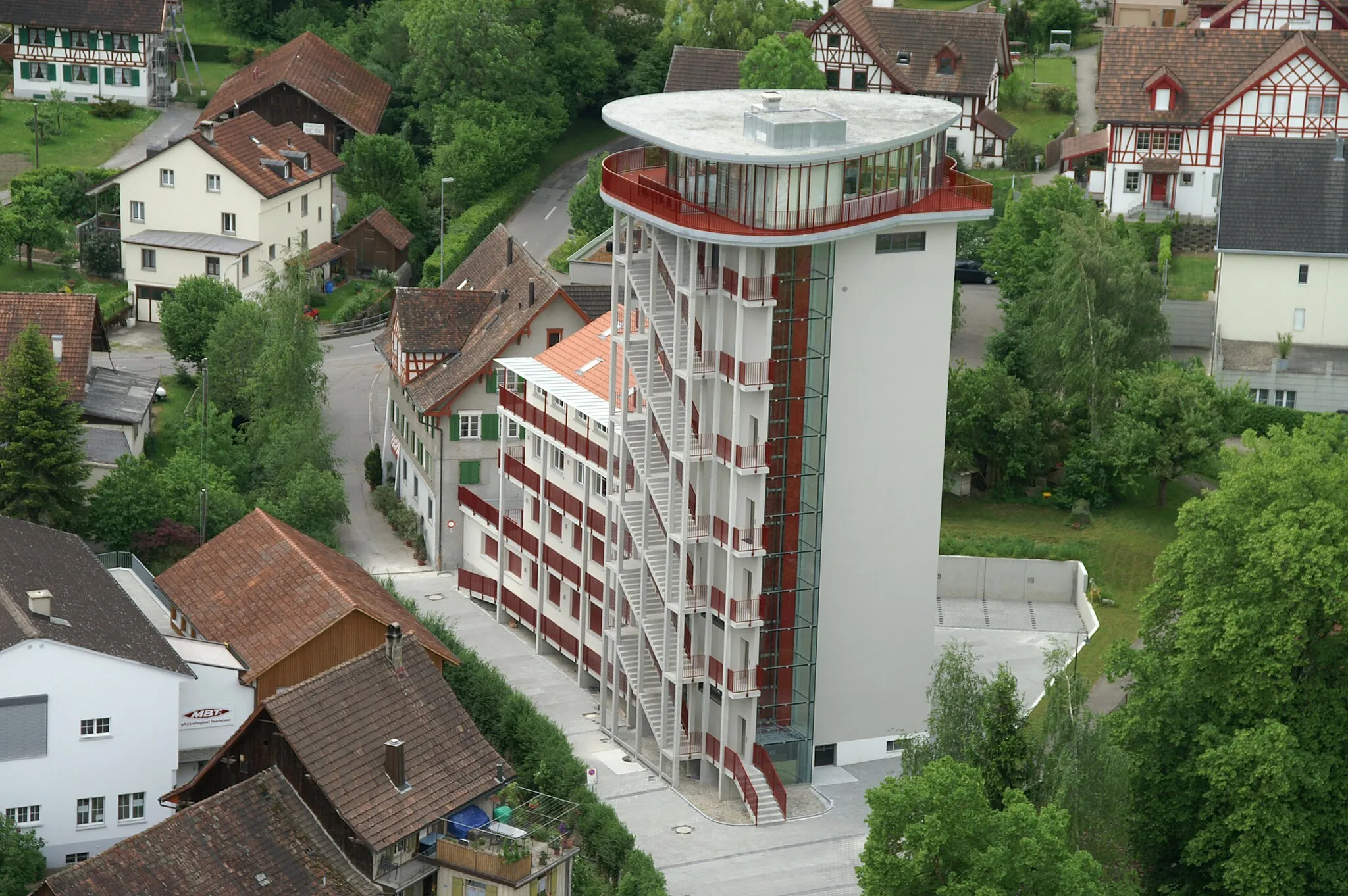 Photo showing: kybun Tower in Roggwil(TG), Switzerland. The 30 meter high tower was a mill before the modification took place in 2006/2007. As of today it's the headquater of the kybun AG. The picture was taken out of a helicopter. In the background you can see typical half-timbered houses.