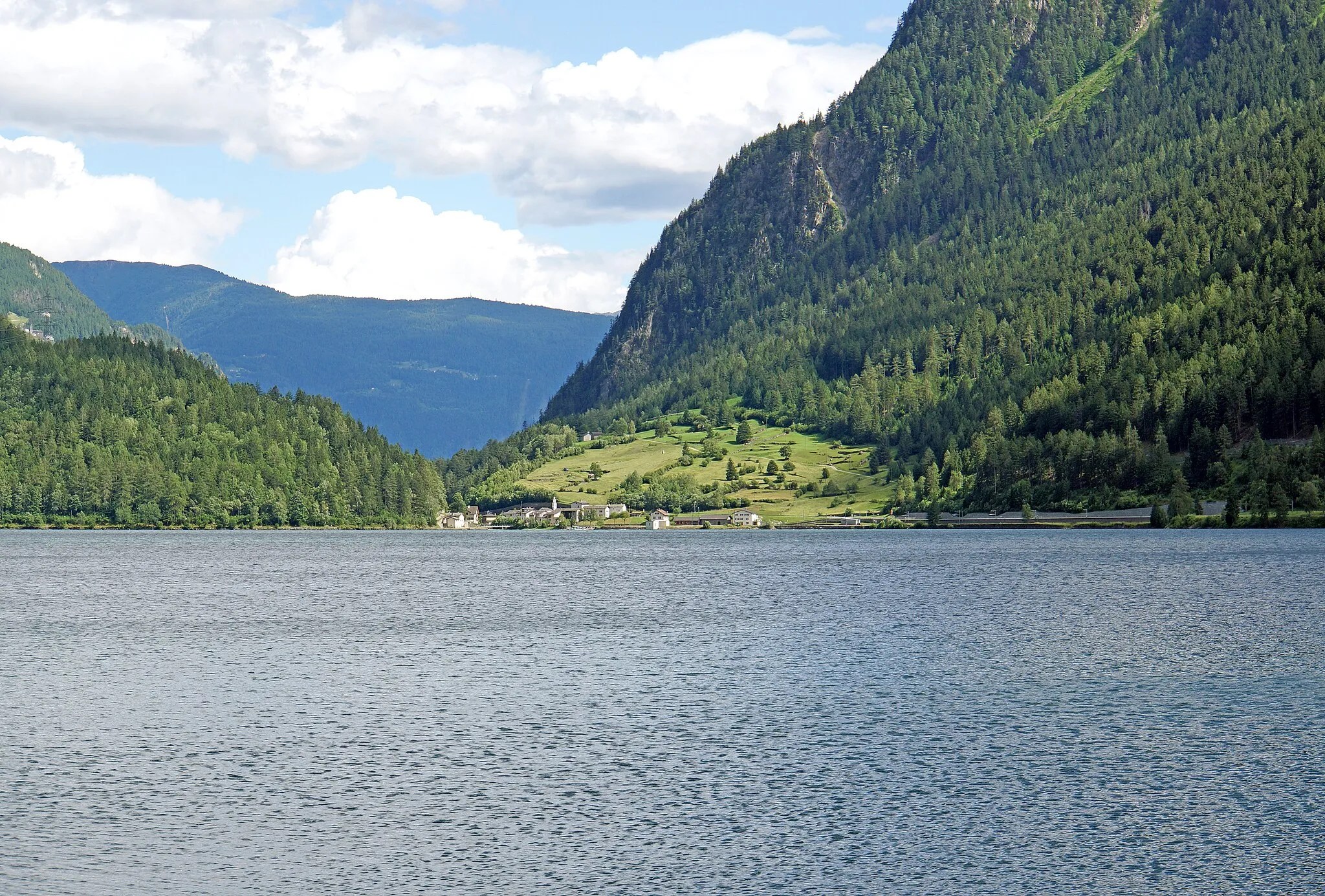 Photo showing: The Lago di Poschiavo and village of Miralago, in the Swiss canton of Graubünden. A view while driving back to St. Moritz. Bus Shot....
