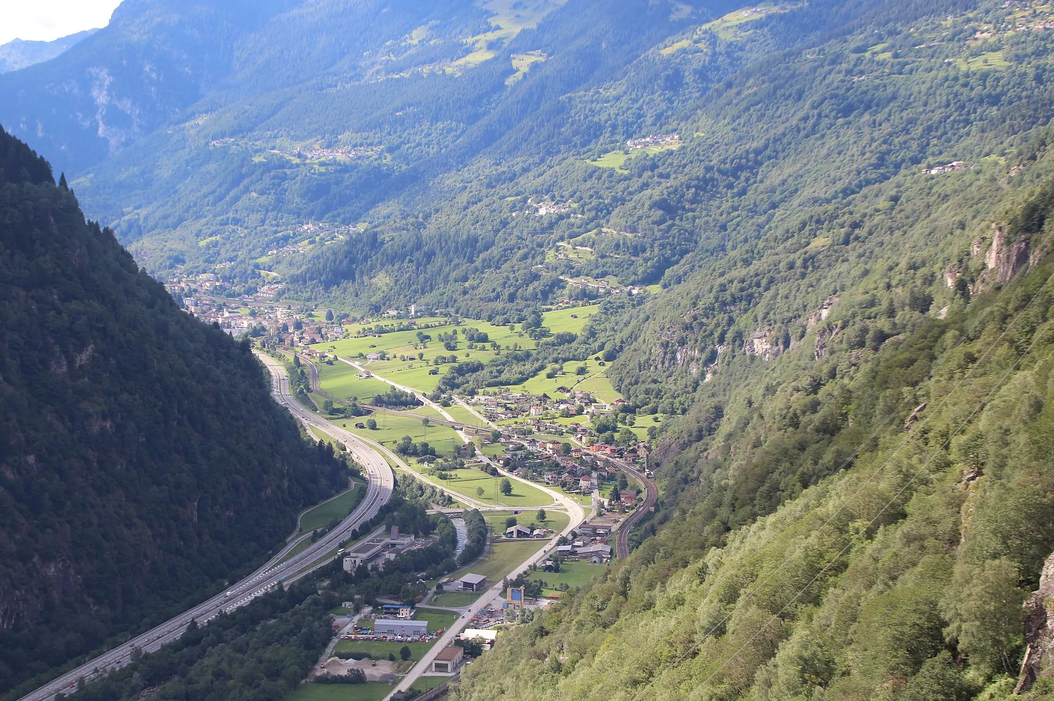Photo showing: Im Tal: de:Chiggiogna, hinten Faido. Am zunehmend bewaldeten Hang, teils in den Bäumen, einige Ortsteile von Faido wie Mairengo, Calpiogna oder Campello.