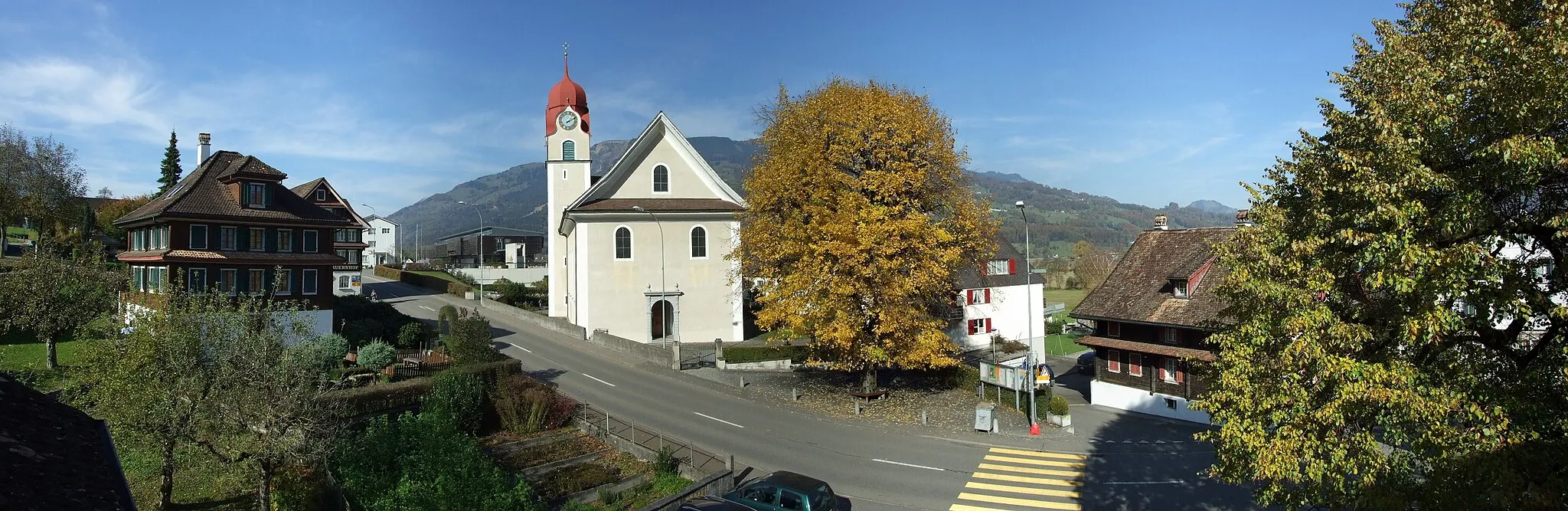Photo showing: Ortskern von Lauerz mit der katholischen Pfarrkirche und einer herbstlich goldfarbenen Linde im Zentrum