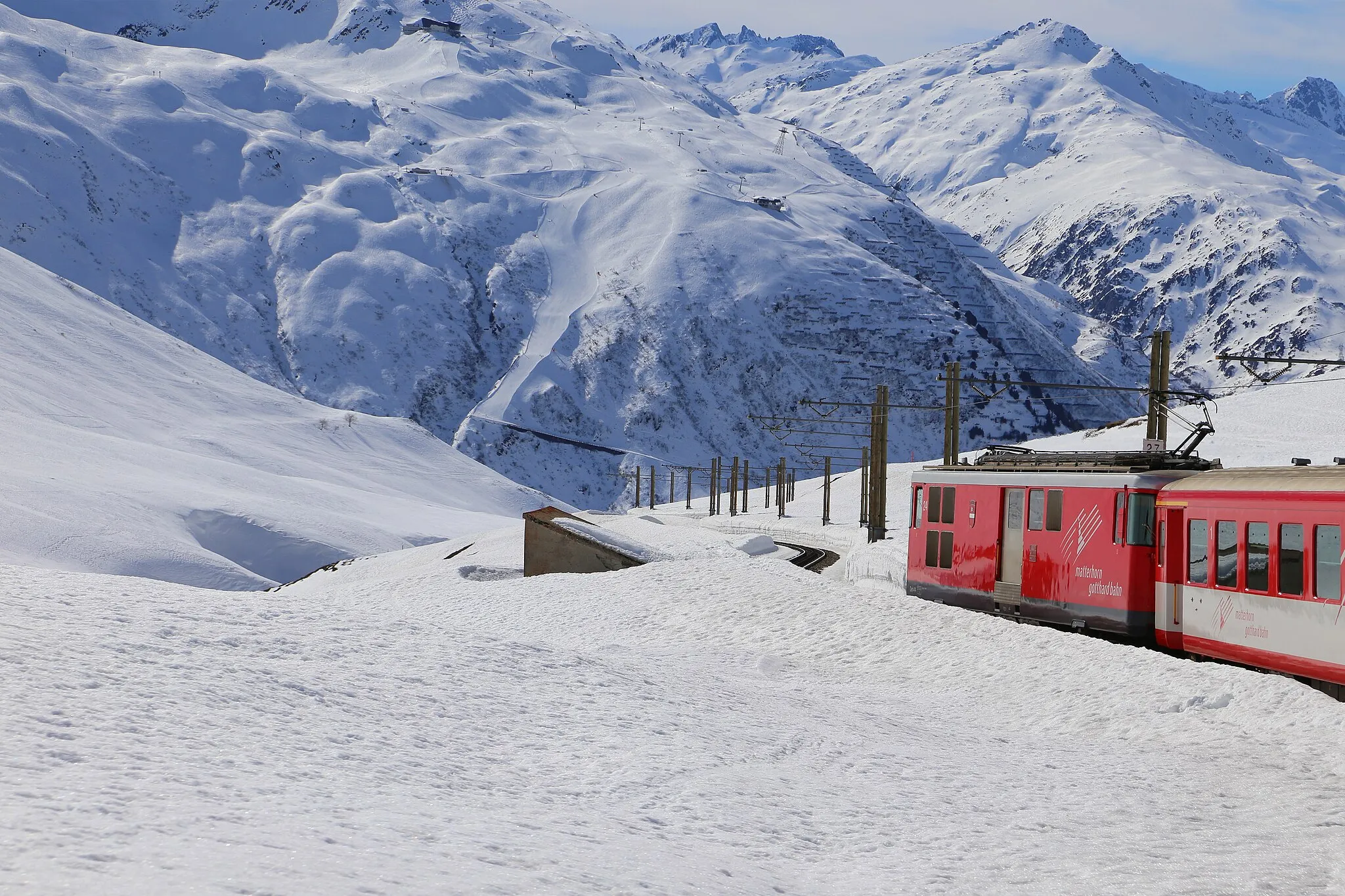 Photo showing: Railway Oberalppass (2,033 meters above sea level) - Andermatt (1,447 meters above sea level) overlooking the ski area Gurschen - Gemsstock. Andermatt in the canton of Uri, Switzerland.