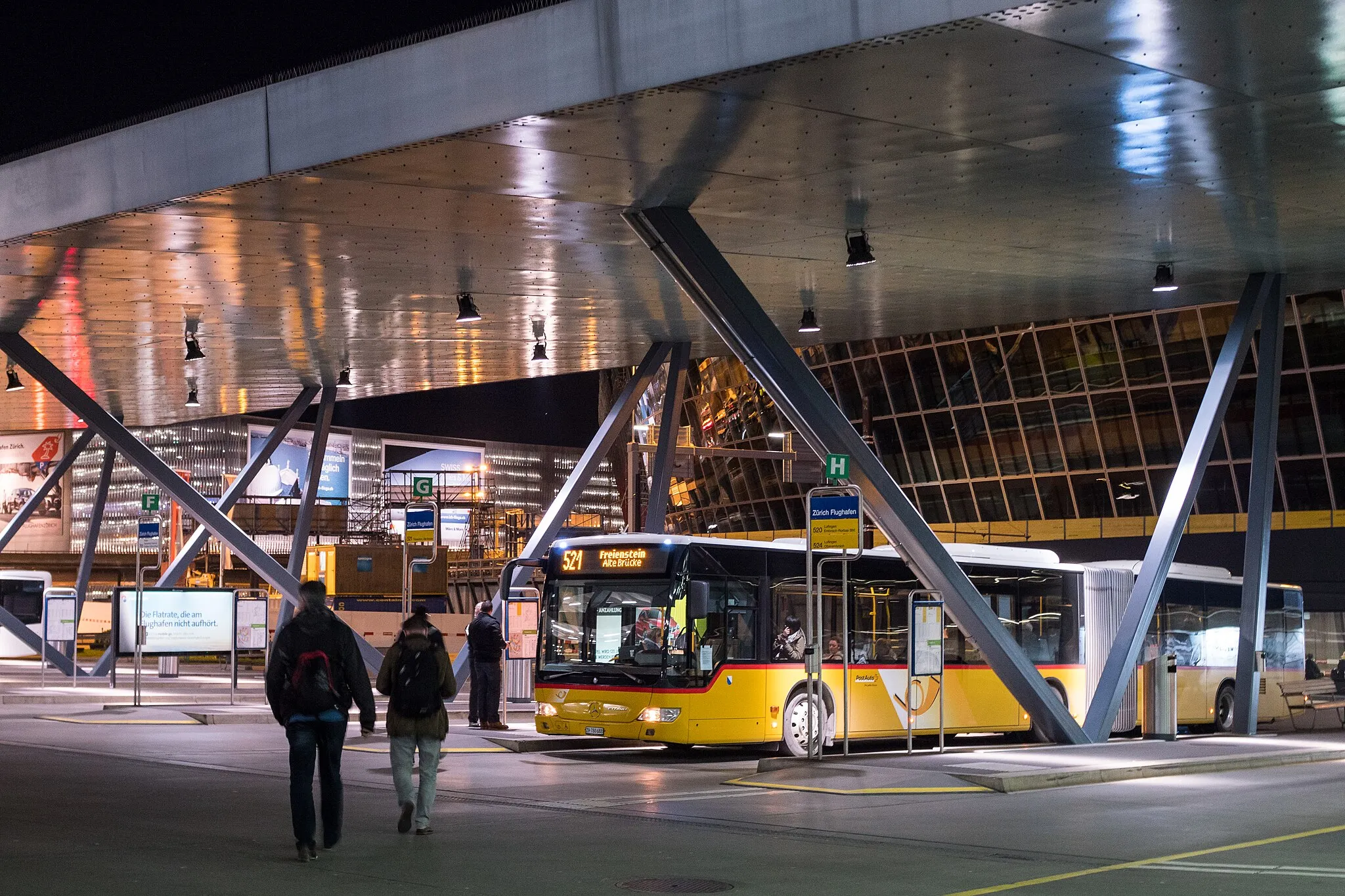 Photo showing: Bus stop at Zurich Airport with postal car "Postauto"