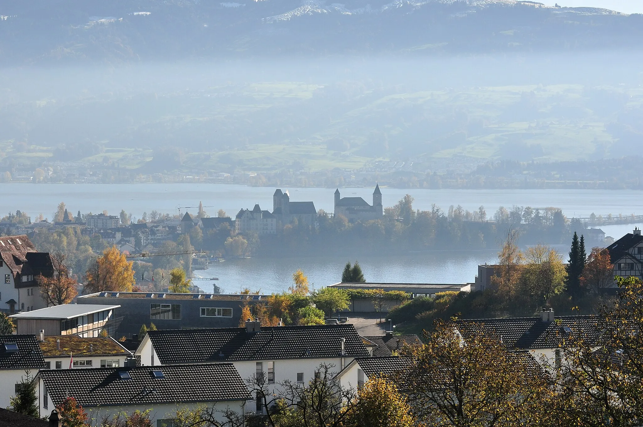 Photo showing: Herrenberg in Rapperswil (SG), i.e. Stadtmuseum, Stadtpfarrkirche St. Johann (St. John's Church), Liebfrauenkapelle and Schloss Rapperswil, as seen from Kempraten-Lenggis (Switzerland); Obersee (upper Lake Zürich) in the background.