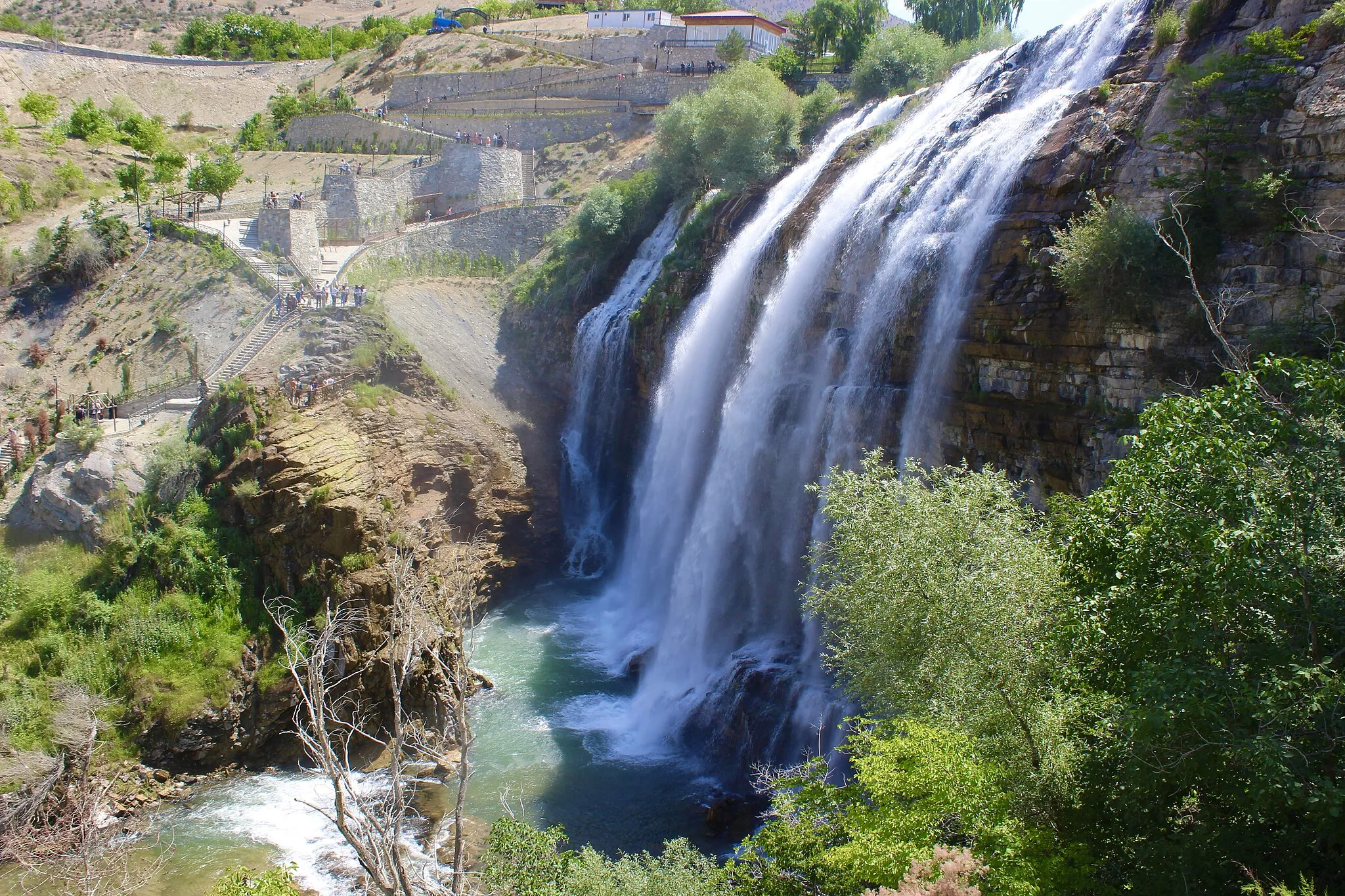 Photo showing: One of the biggest waterfalls in Turkey, Tortum Waterfall is connected to Lake Tortum and it is a famous landmark among tourists and visitors. The picture, which is taken at the end of June, shows the waterfall in a period when it has a great flow.
