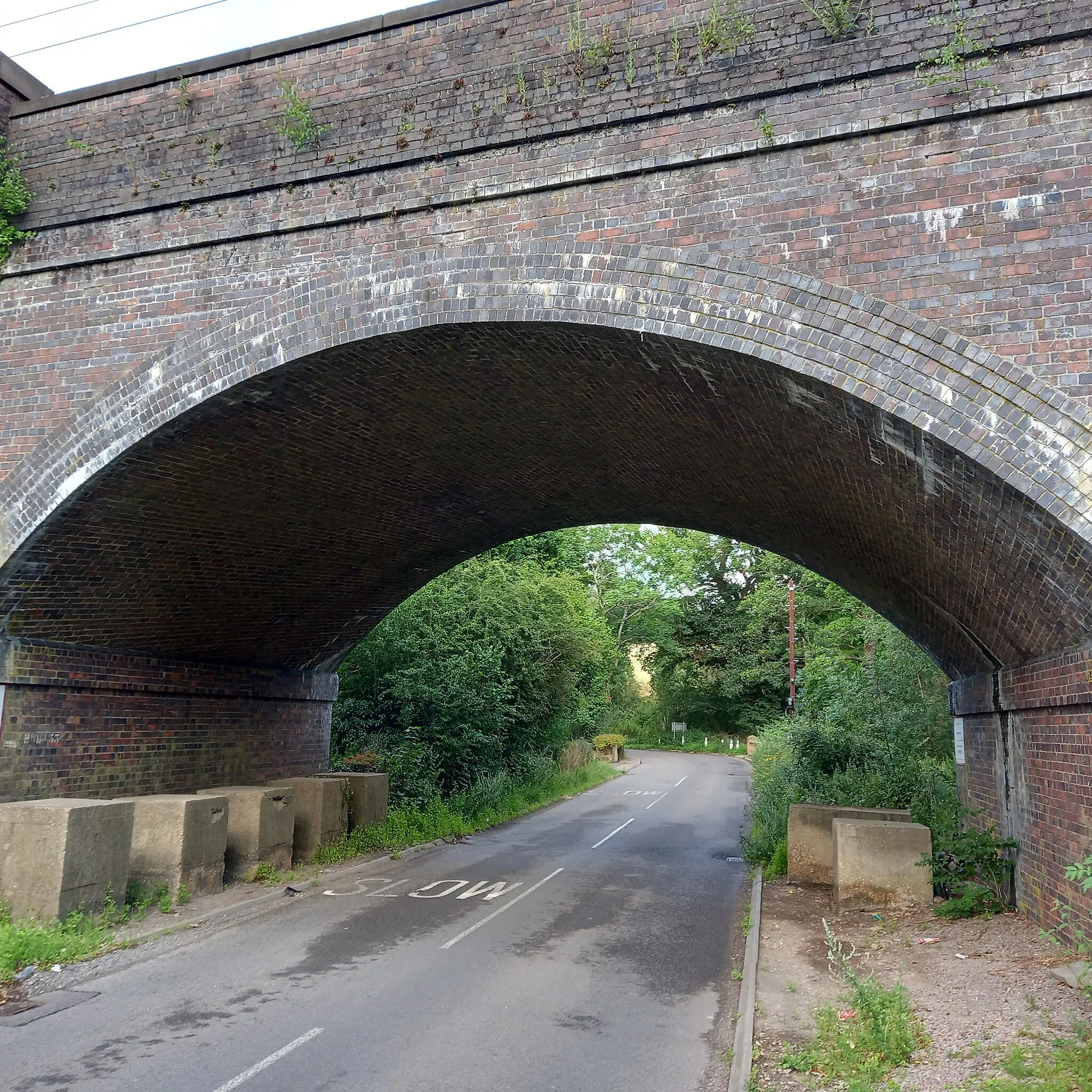 Photo showing: Anti-tank blocks under the railway bridge at Darnicle Hill near Newgate Street in Hertfordshire. They formed part of the 1940 London Stop Line Outer and dozens of other blocks follow the line of the railway embankment in both directions.