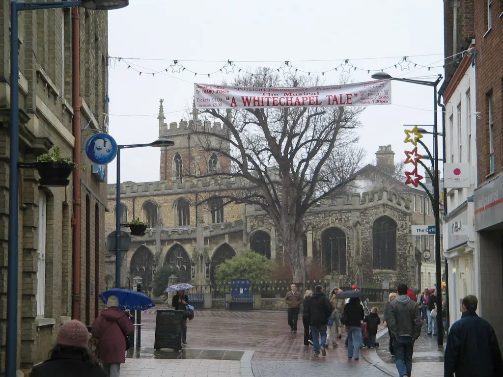 Photo showing: The town centre of Huntingdon, Cambridgeshire, UK, looking North along the High Street and showing All Saints' Church on the Market Square