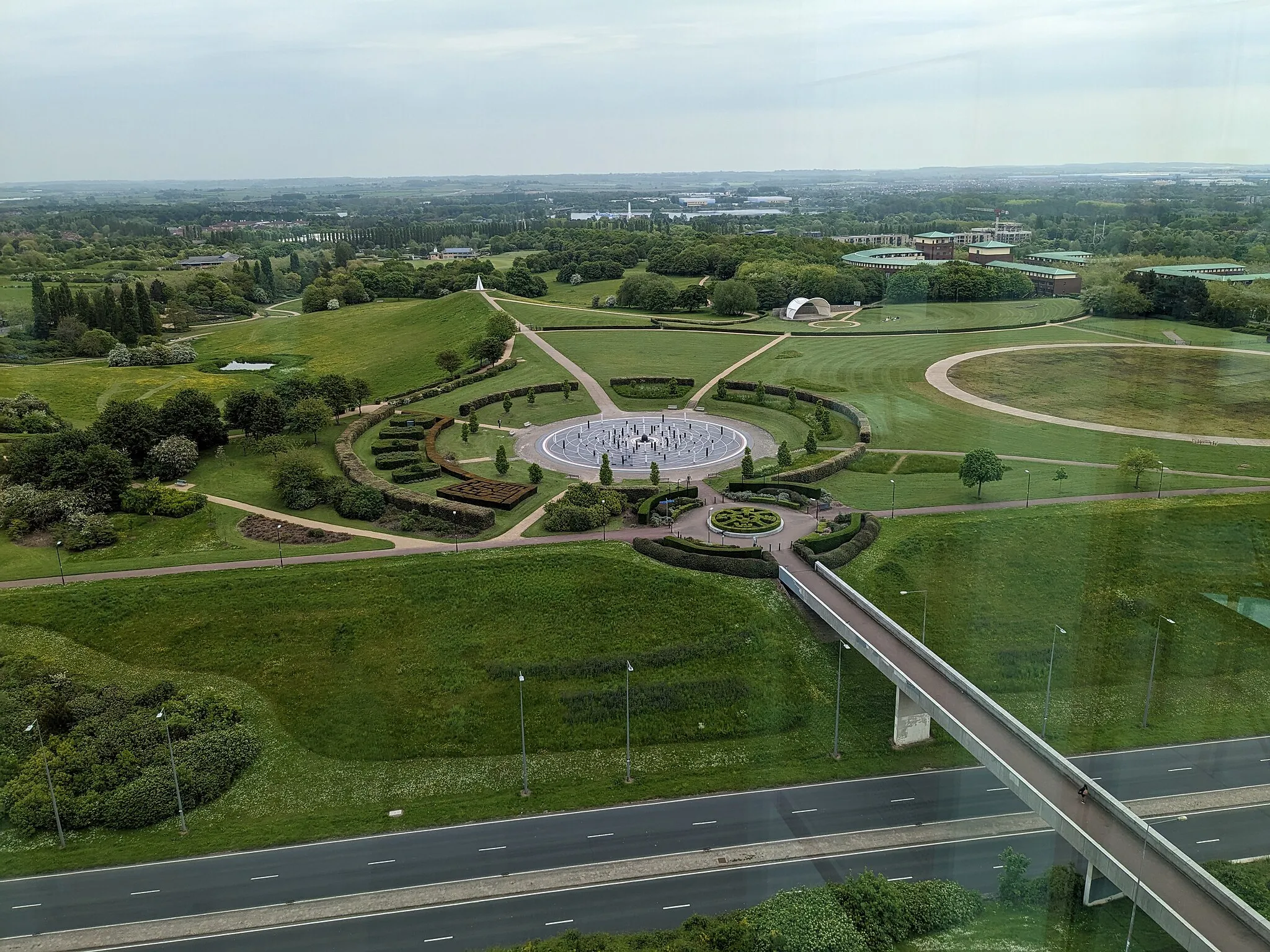 Photo showing: In the foreground (in cutting), Marlborough Street; in the middle, the Milton Keynes Rose memorial space; the Belvedere leading to the Light Pyramid (a beacon); in the distance, Willen Lake; on the horizon, Cranfield in Bedfordshire