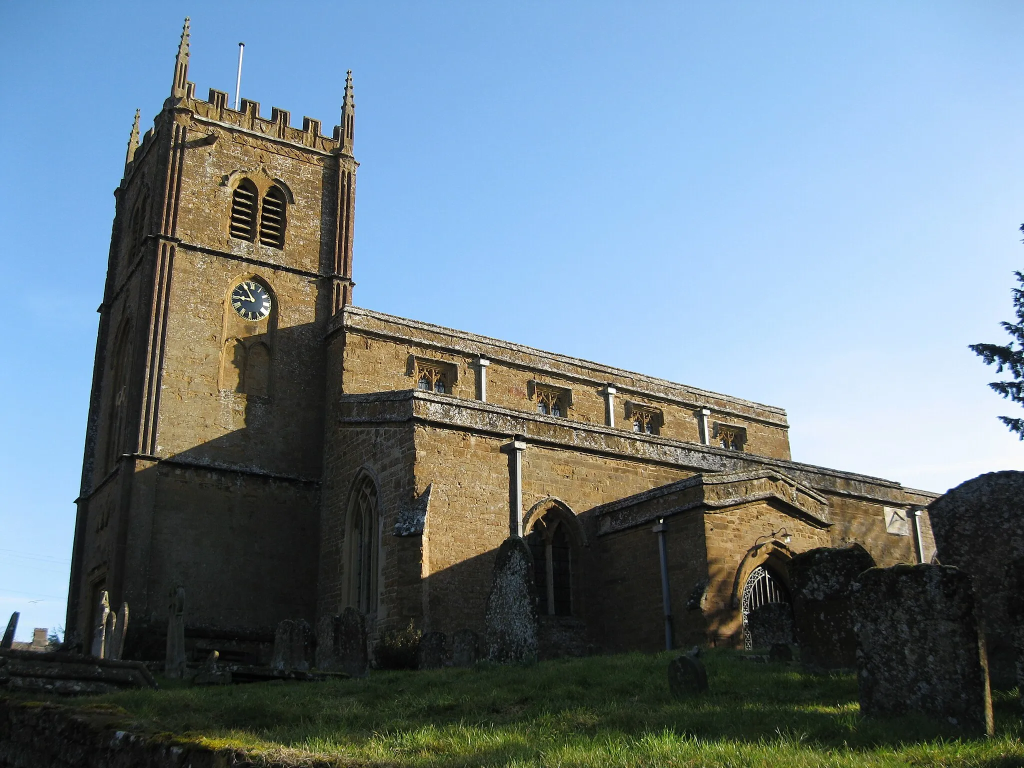 Photo showing: Church of England parish church of All Saints, Wroxton, Oxfordshire. The church is 14th and 15th century. The tower was designed by Sanderson Miller and begun in 1748.