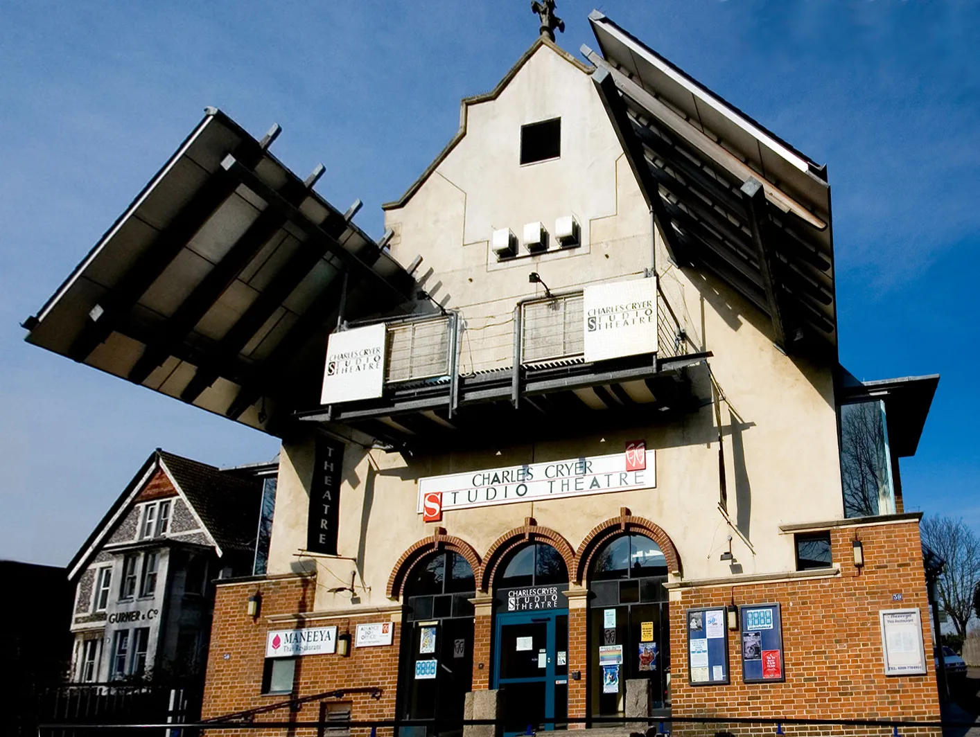 Photo showing: The Charles Cryer Studio Theatre, Carshalton. This was originally built in the 1870's as a public hall. The building has also been used as a roller-skating rink and a cinema. It became the present theatre in 1991. The building also incorporates a good Thai restaurant (Maneeya) at ground level, which is entered from the side of the building and hence not fully in view.