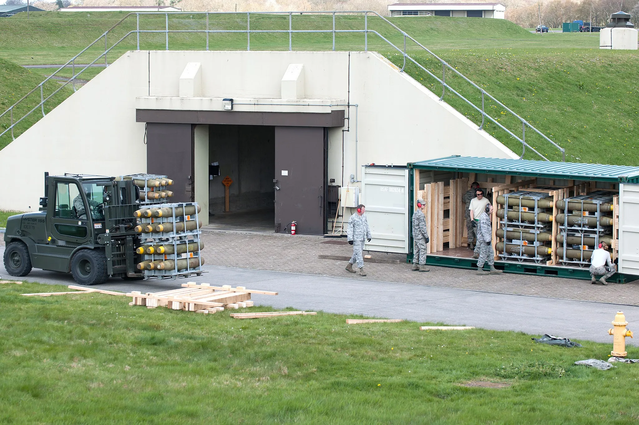 Photo showing: RAF WELFORD, United Kingdom - A crew from the 420th Munitions Squadron add munitions to a container. (U.S. Air Force photo by Senior Airman Joel Mease)