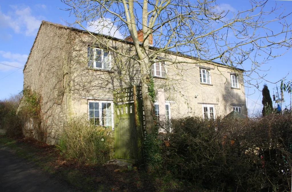 Photo showing: 'The Cottage', Worsham with peacock at bird feeder