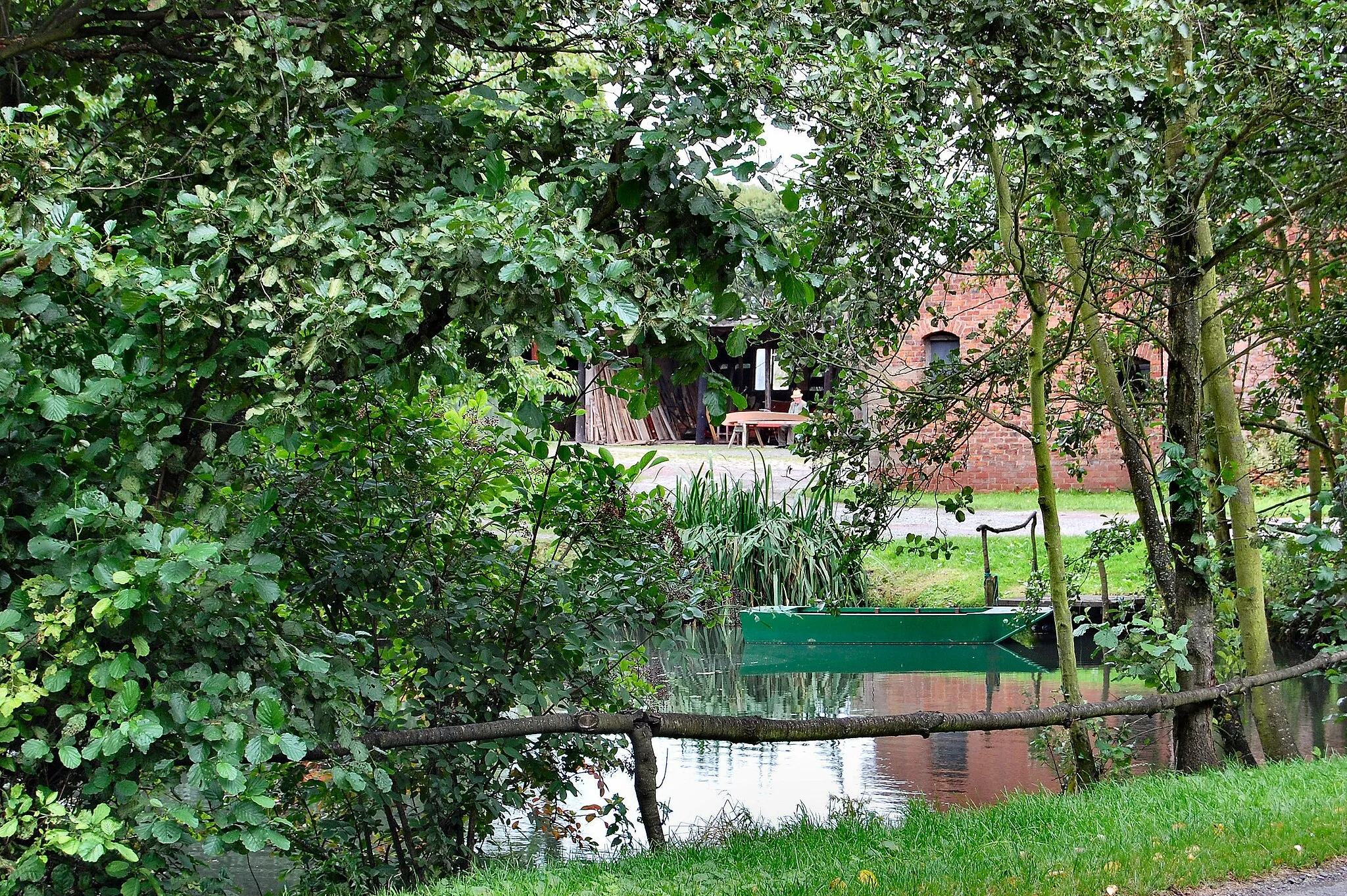 Photo showing: Lovely little pond in this small village of Croft which is just outside the big town of Warrington. The chap in the background is happily working away making a small wooden boat.  Ron.