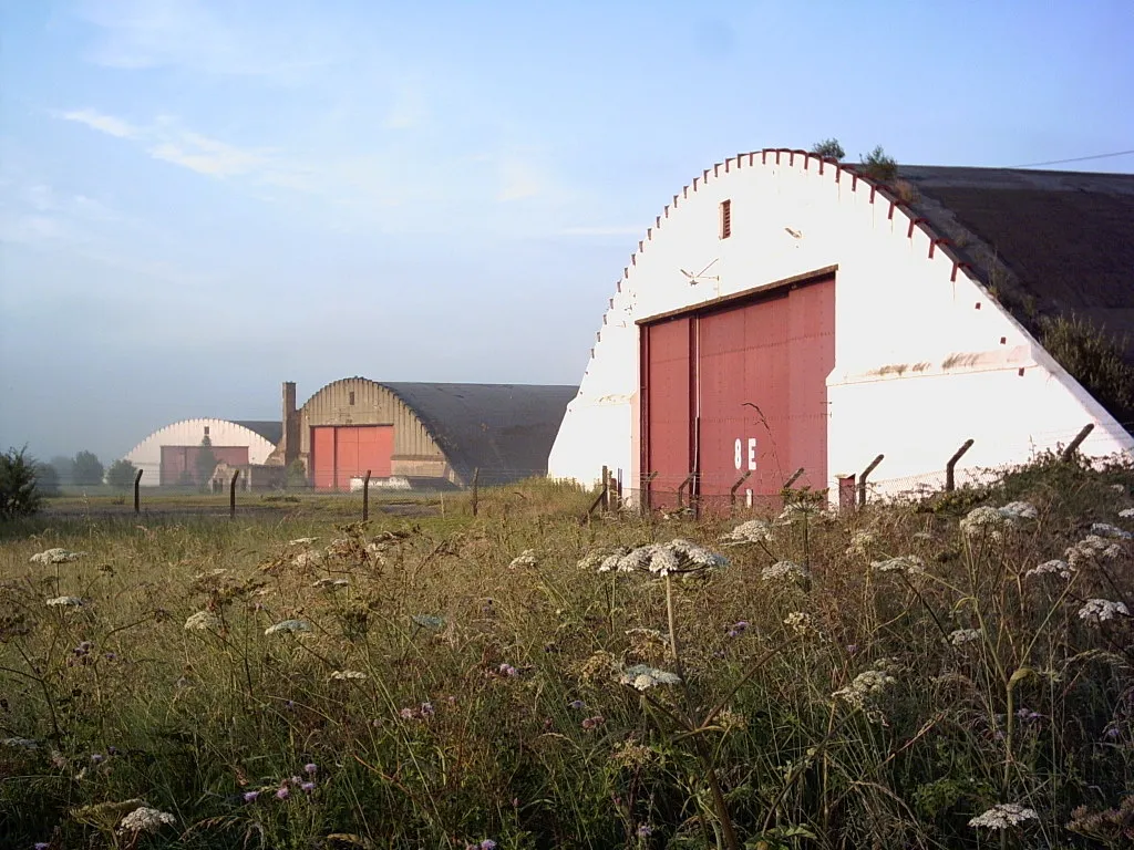 Photo showing: Three of the hangars of the old Burtonwood Air Base. They are due to be demolished as part of a large business development, http://www.omegaopportunity.com/default.htm.
Photographed by Peter Leather from Joy Lane by Joy Lane Farm.  Grid Ref SJ559915 looking south.