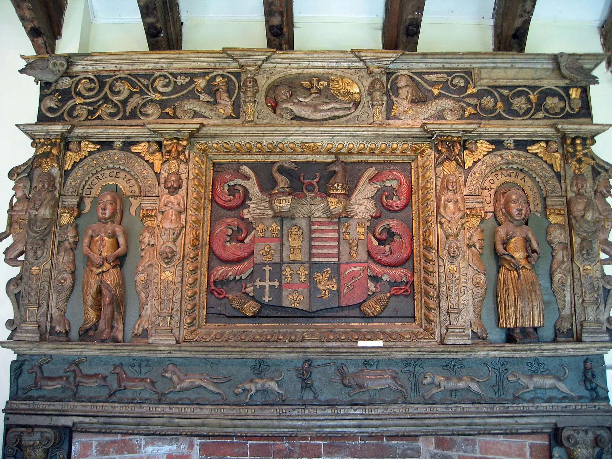 Photo showing: Chimney piece removed from Tabley Old Hall, Cheshire, now in the Old Hall Room at Tabley House. Built to memorialise the 1611 marriage of Peter Leycester (1588–1647) of Tabley to Elizabeth Mainwaring, a daughter of Sir Randle Mainwaring of Over Peover, Cheshire. The arms show Leycester (Azure, a fess gules between three fleurs-de-lys or) of four quarters, impaling Mainwaring (Barry of twelve argent and gules) of four quarters. The arms of Leycester are a known contravention of the heraldic "rule of tinctures".( Encyclopaedia Britannica, 1902, 9th and 10th editions, "Heraldry"[1])[2]