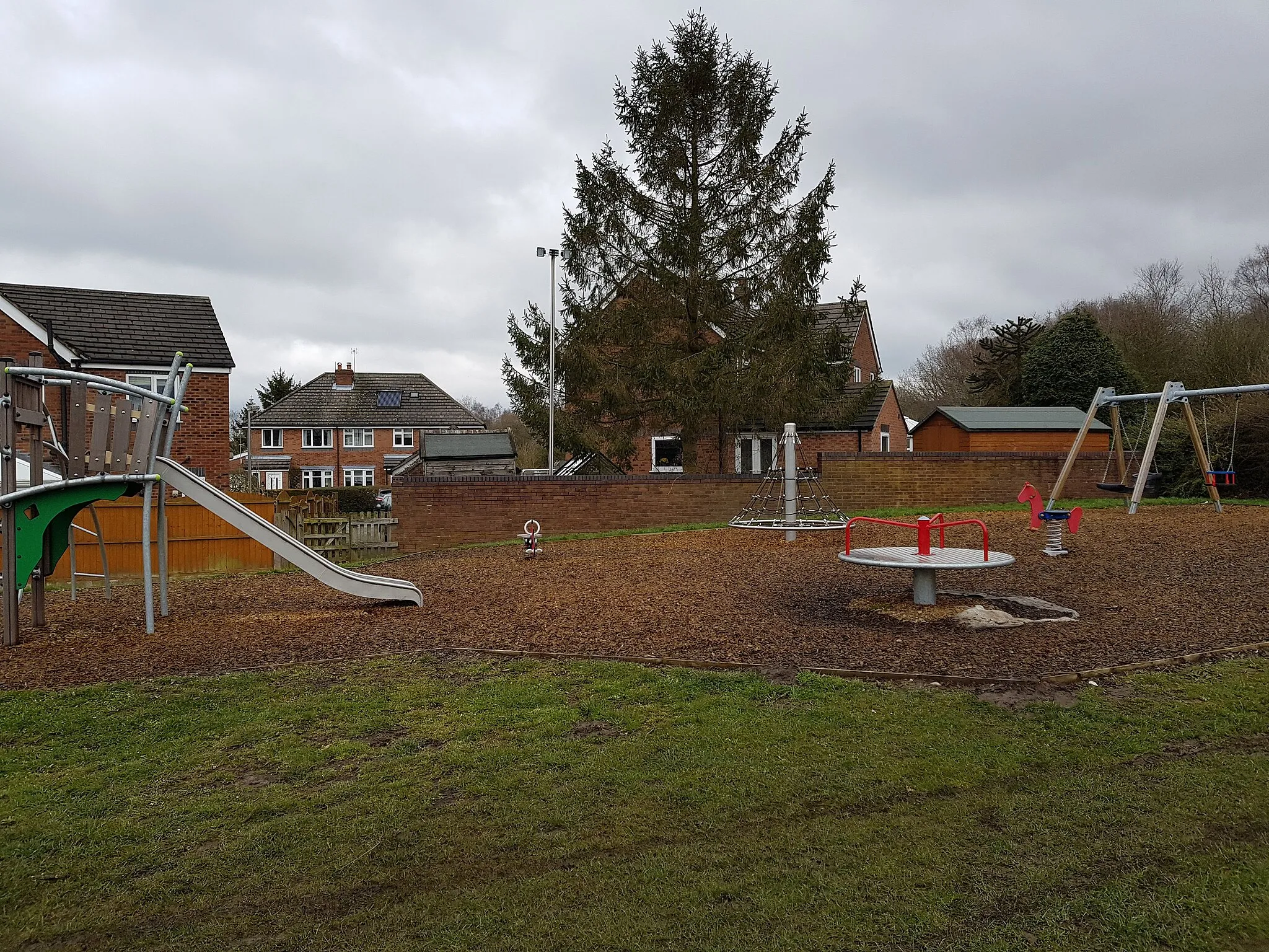 Photo showing: This bench was dedicated
to the hard work and
enthusiasm of
Mrs Sylvia Jenkinson
in pursuance of
Bosley village green playa…