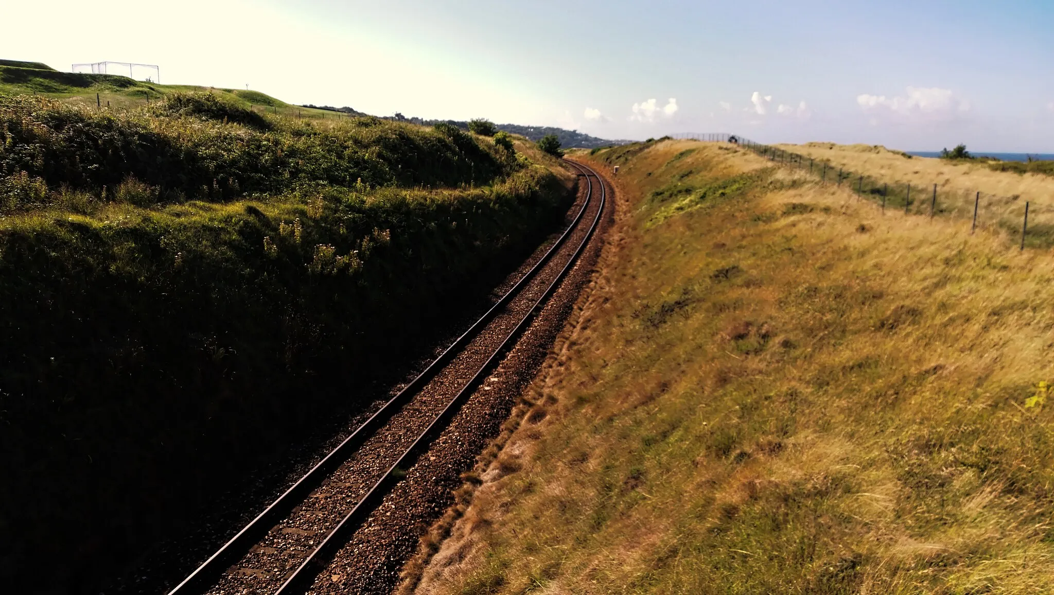 Photo showing: The railway line running through the top of Porthkidney Beach, Lelant...