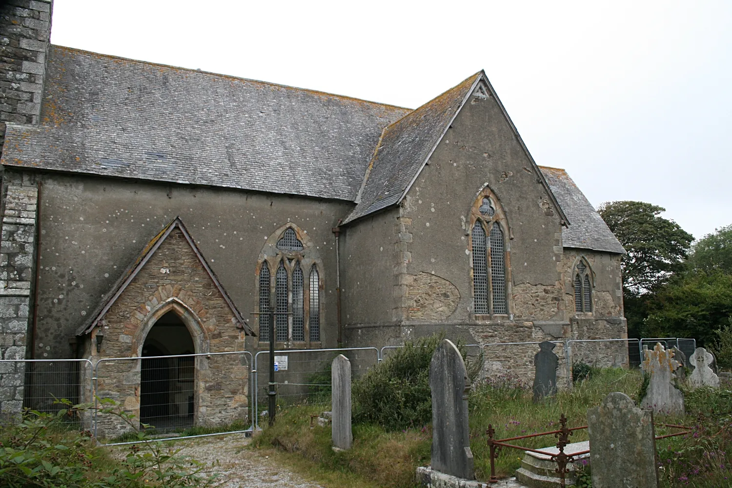 Photo showing: The South entrance at St Peter's Mithian. The wire fence is clearly visible