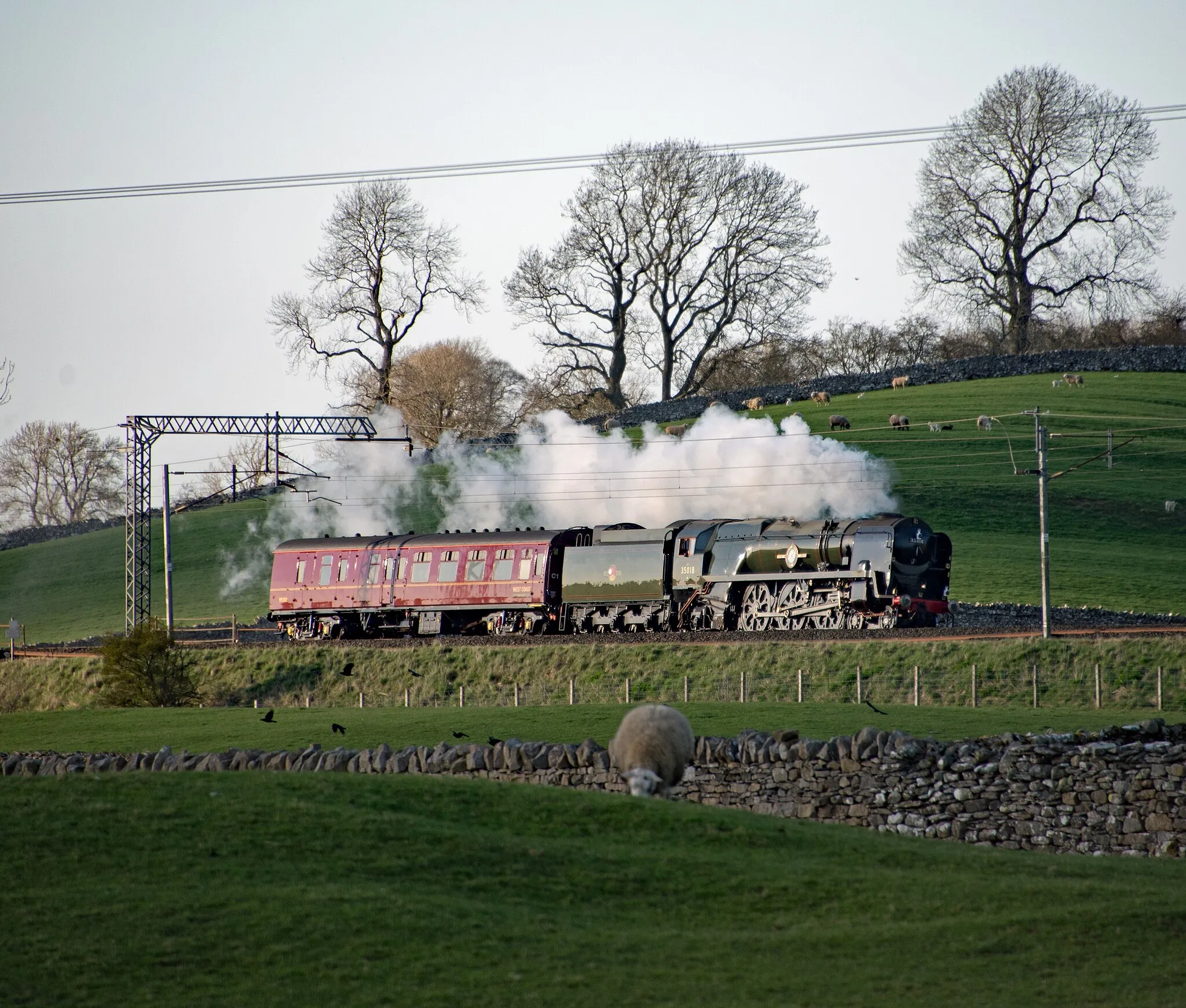 Photo showing: 35018 British India Line heading up and over Shap summit on its way back to Carnforth from Carlisle having starred in its performance with the GB XI excursion which it hauled from York on its inaugural run over the Settle Carlisle line. It seemed a long while since I started the day at Orton Scar Cafe so Shap Chippy was my next stop.