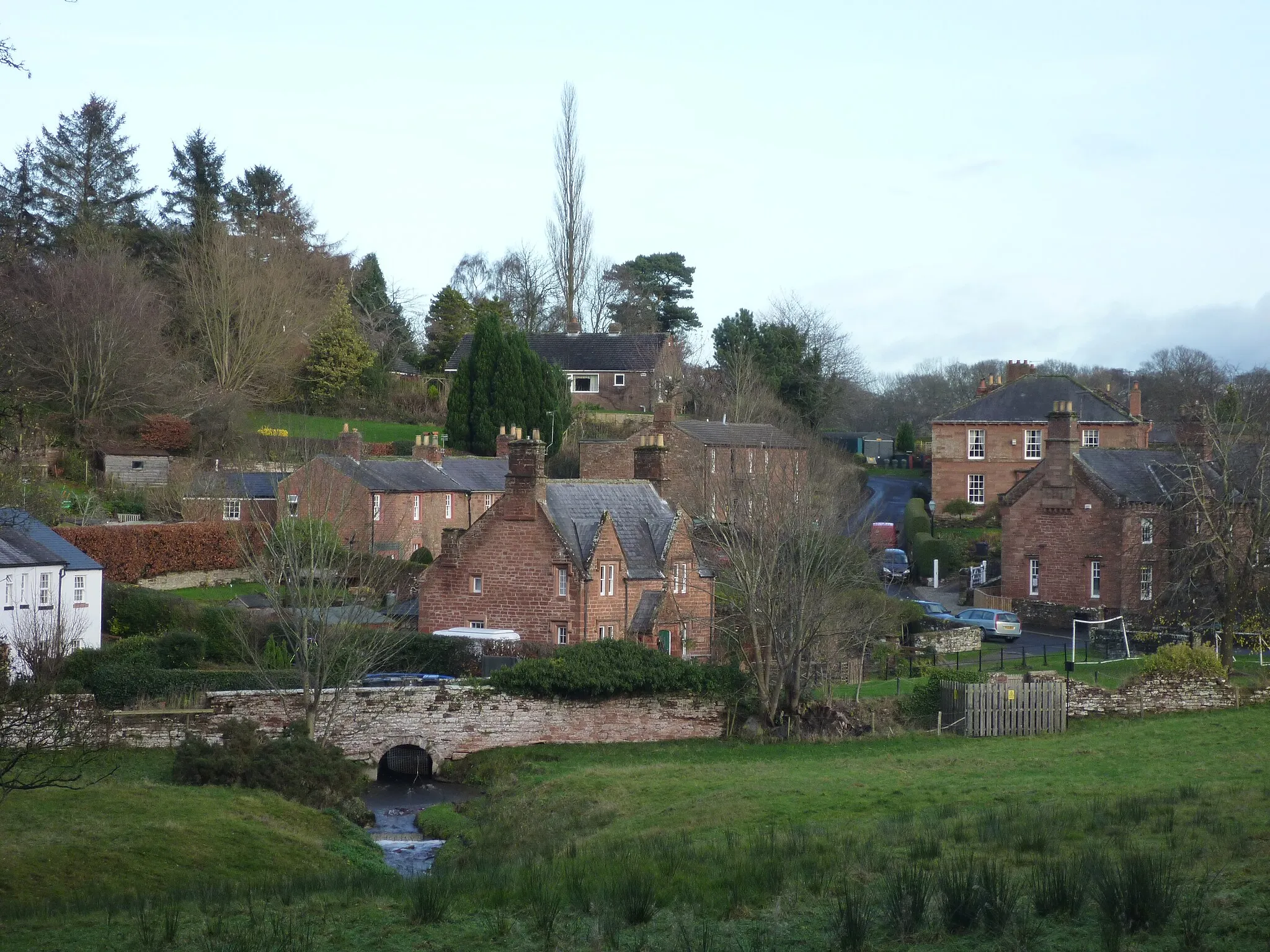 Photo showing: Great Corby, Carlisle, Cumbria, UK. View of lower village green, including primary school. Taken from 'The Rash'.