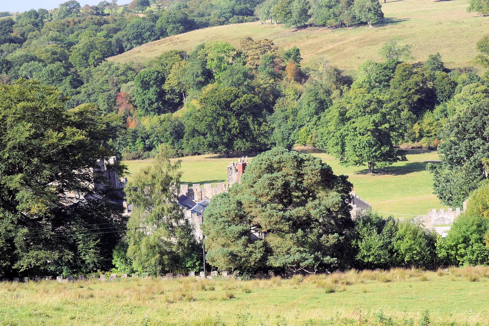 Photo showing: Featherstone Castle through the trees