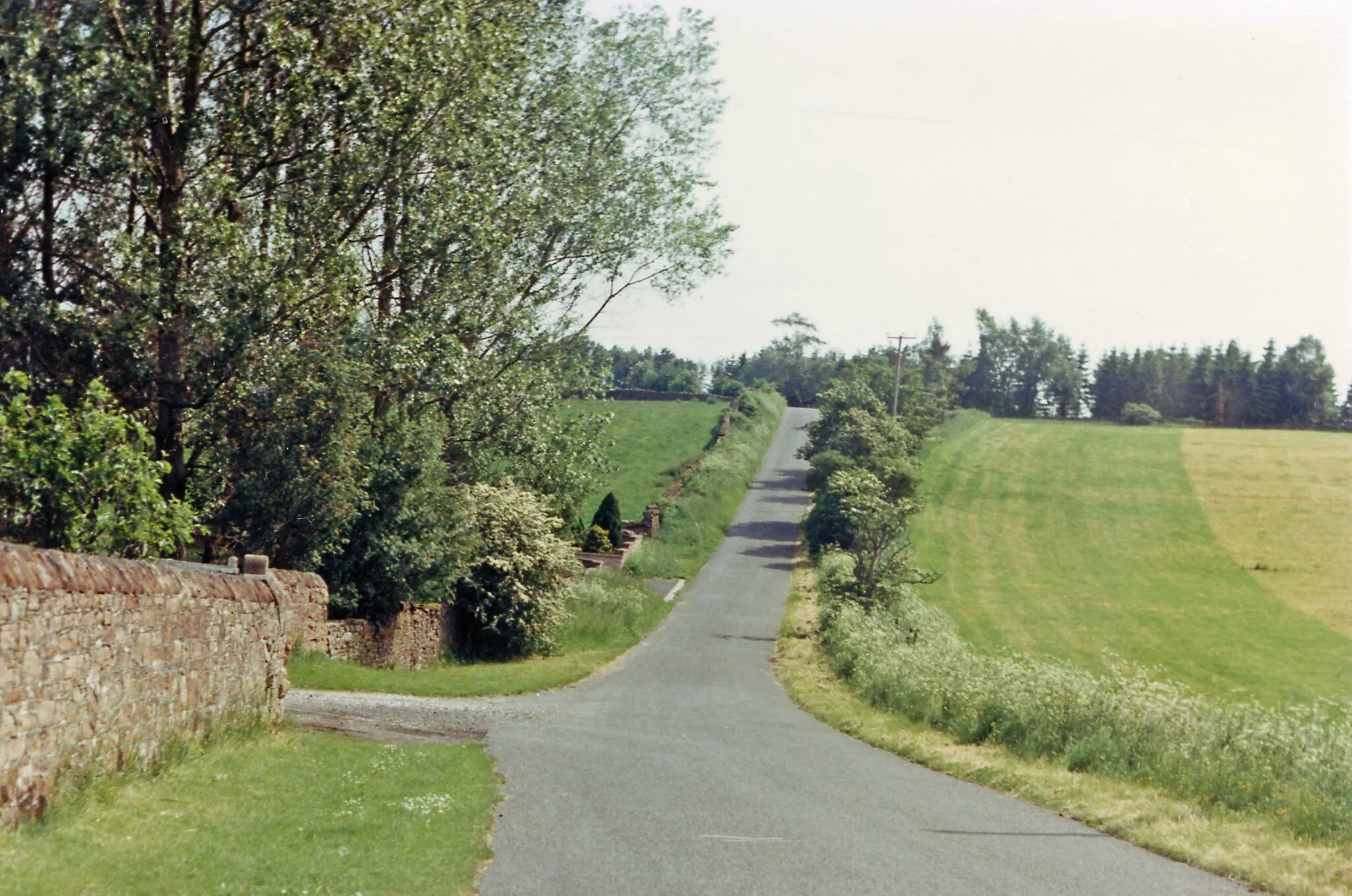 Photo showing: Cliburn: road to village from former station, 1986.
View southward from Station House.